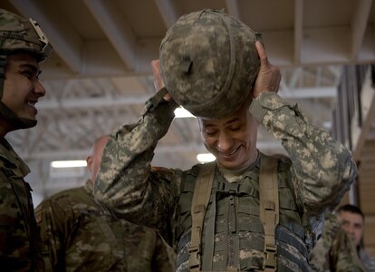 A command sergeant major puts on approximately 80 pounds of protective equipment to participate in a Military Police High Physical Demand Testing Analysis drill during a command sergeants majors and senior enlisted leader forum hosted by the 200th Military Police Command in Los Alamitos, Calif., Feb 15-18. 