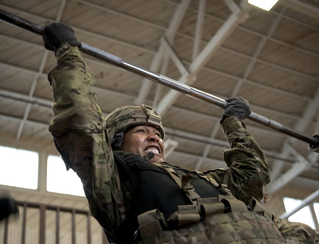 1st Sgt. Tomeka Johnson, senior enlisted leader of the 200th Military Police Command Headquarters Company, lifts weights over her head during the final step of the Military Police High Physical Demand Testing Analysis, which requires soldiers to wear approximately 80 pounds of protective equipment. The drill was part of a command sergeants majors and senior enlisted leaders forum hosted by the 200th Military Police Command in Los Alamitos, Calif., Feb 15-18, to discuss proactive personnel management of Soldiers in the U.S. Army Reserve. 