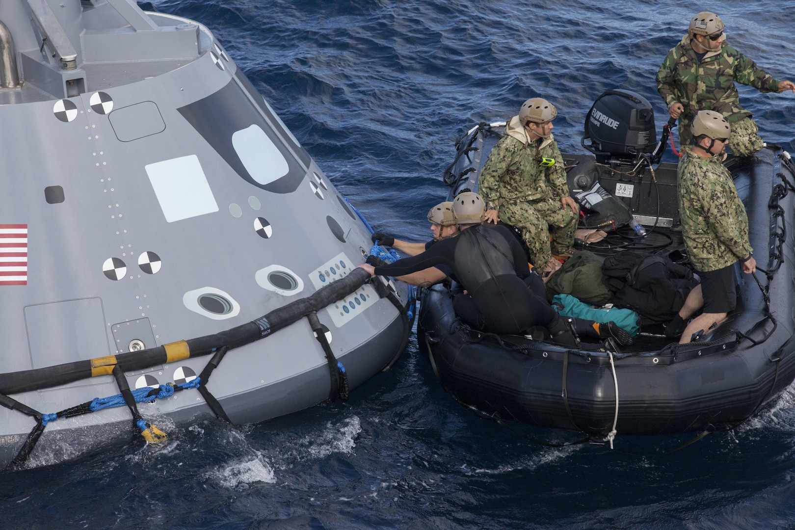 U.S. Navy divers and other personnel in a Zodiac boat secure a harness around a test version of the Orion crew module during Underway Recovery Test 5 in the Pacific Ocean off the coast of California on Oct. 28, 2016. Members of the New York Air National Guard's 106th Rescue Wing will participate in a mission in Hawaii designed to test space capsule recovery techniques and equipment, although they will not work with a capsule simulator like this one.Orion is the exploration spacecraft designed to carry astronauts to destinations not yet explored by humans. 