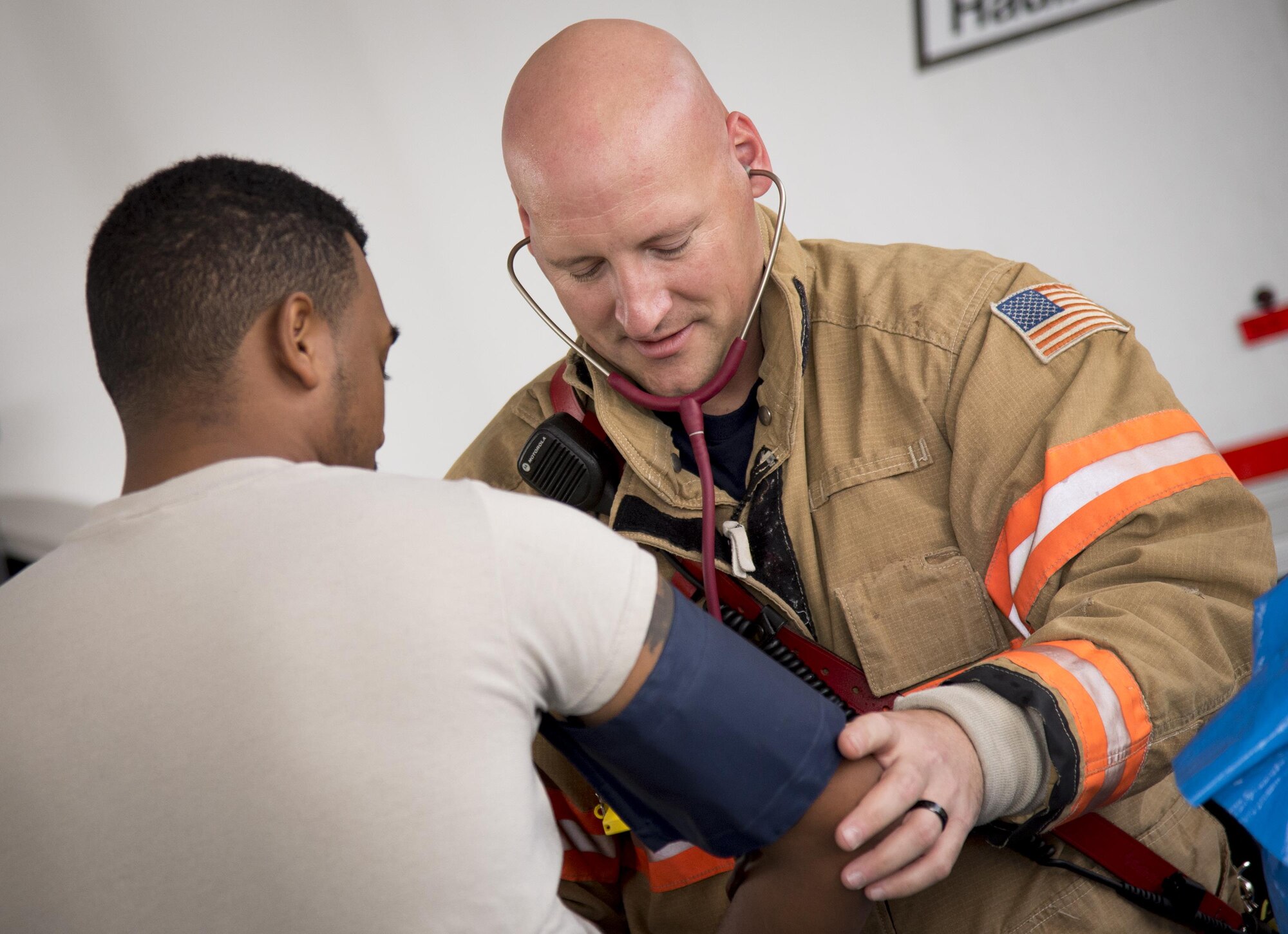 Jerry Carlton, a 96th Test Wing firefighter, checks blood pressure and pulse of Airman 1st Class Donel Wanton, 96th Aerospace Medicine Squadron, before suit up time during the hazardous material portion of an exercise Feb. 22 at Eglin Air Force Base, Fla.  The chemical, biological, nuclear response exercise tested the procedures of emergency response, explosive ordnance disposal, disaster management and bioenvironmental agencies among others.  (U.S. Air Force photo/Samuel King Jr.)