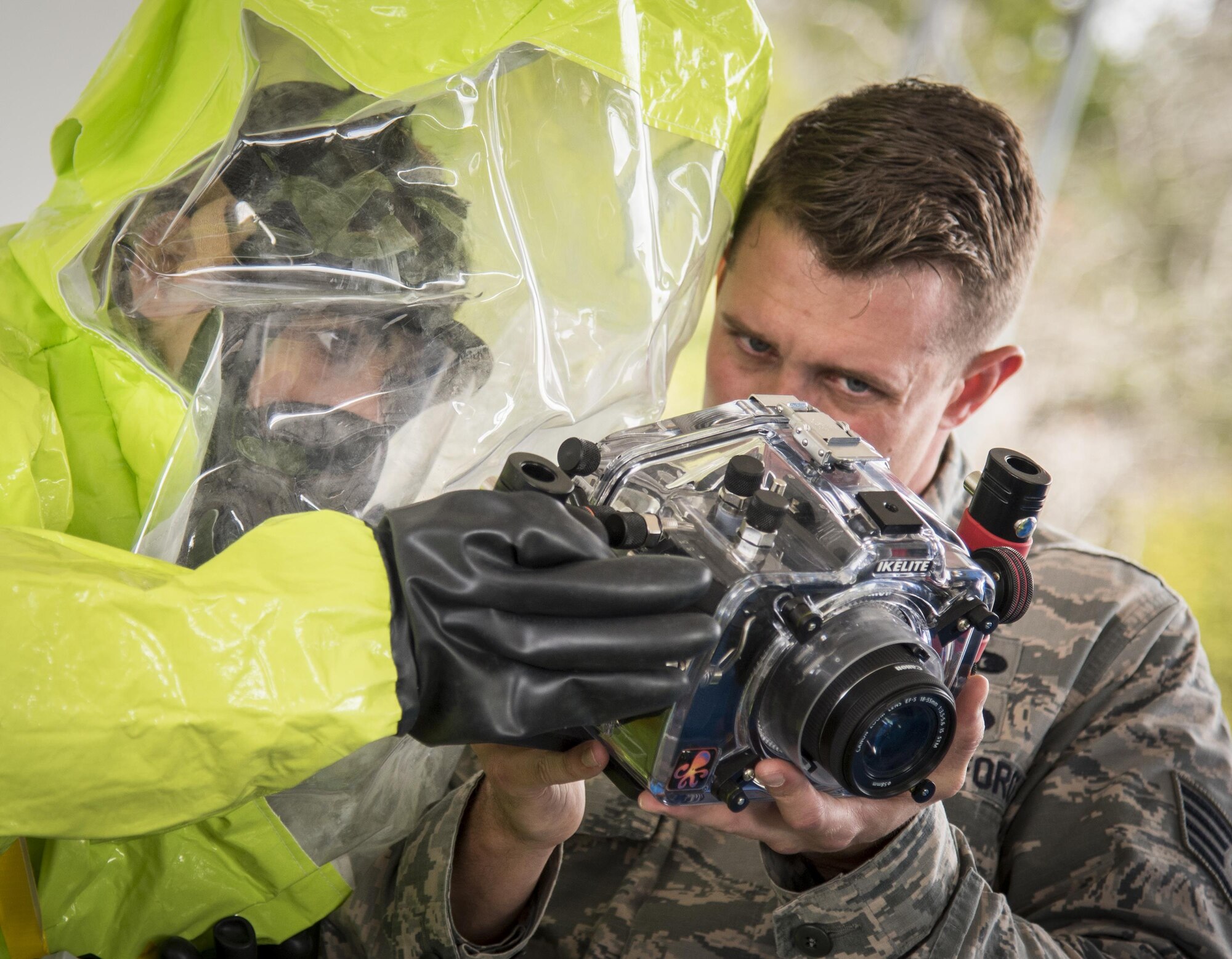 Airmen ensure the camera settings are correct during a hazardous material portion of an exercise Feb. 22 at Eglin Air Force Base, Fla.  The chemical, biological, nuclear response exercise tested the procedures of emergency response, explosive ordnance disposal, emergency management and bioenvironmental agencies among others.  (U.S. Air Force photo/Samuel King Jr.)