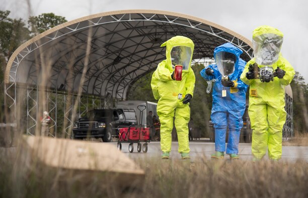 Airmen in protective gear move toward a decontamination area during a hazardous material portion of an exercise Feb. 22 at Eglin Air Force Base, Fla.  The chemical, biological, nuclear response exercise tested the procedures of emergency response, explosive ordnance disposal, emergency management and bioenvironmental agencies among others.  (U.S. Air Force photo/Samuel King Jr.)