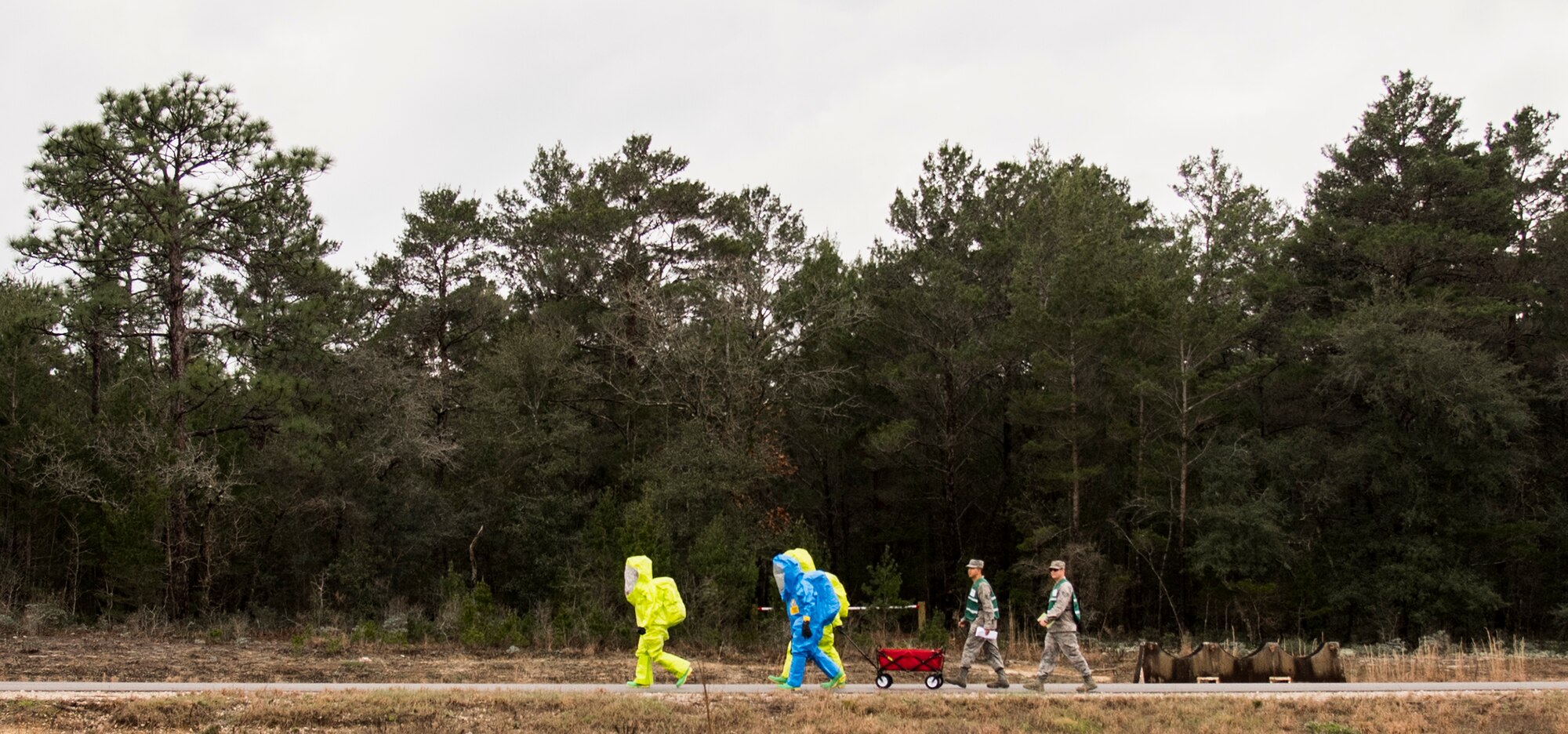 Airmen in protective gear move toward a decontamination area during a hazardous material portion of an exercise Feb. 22 at Eglin Air Force Base, Fla.  The chemical, biological, nuclear response exercise tested the procedures of emergency response, explosive ordnance disposal, emergency management and bioenvironmental agencies among others.  (U.S. Air Force photo/Samuel King Jr.)