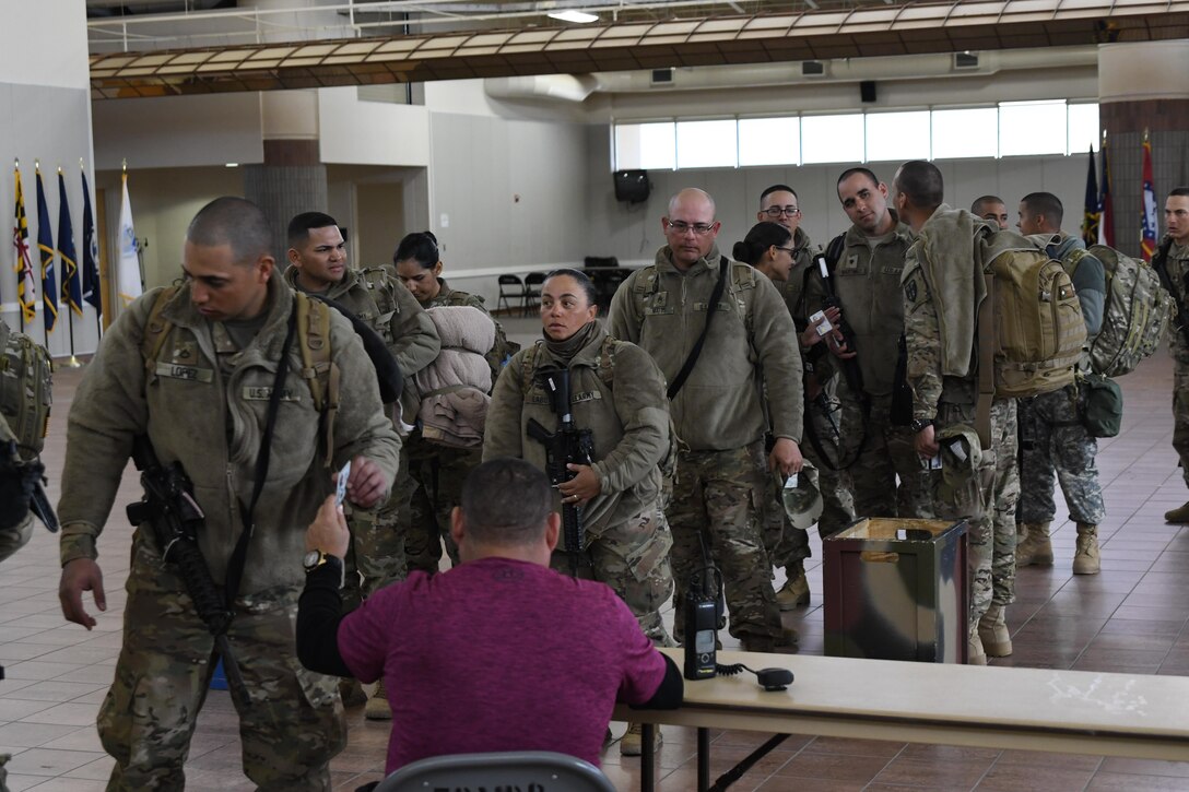 Soldiers assigned to the 207th Engineer Company, Kentucky Army National Guard and the 215th Engineer Company, U.S. Army Reserve are weighed, manifested and processed prior to boarding an aircraft at the Silas L. Copeland Arrival/Departure Airfield Control Group here Feb. 2, 2017 for a deployment in support of Operation Freedom’s Sentinel.
