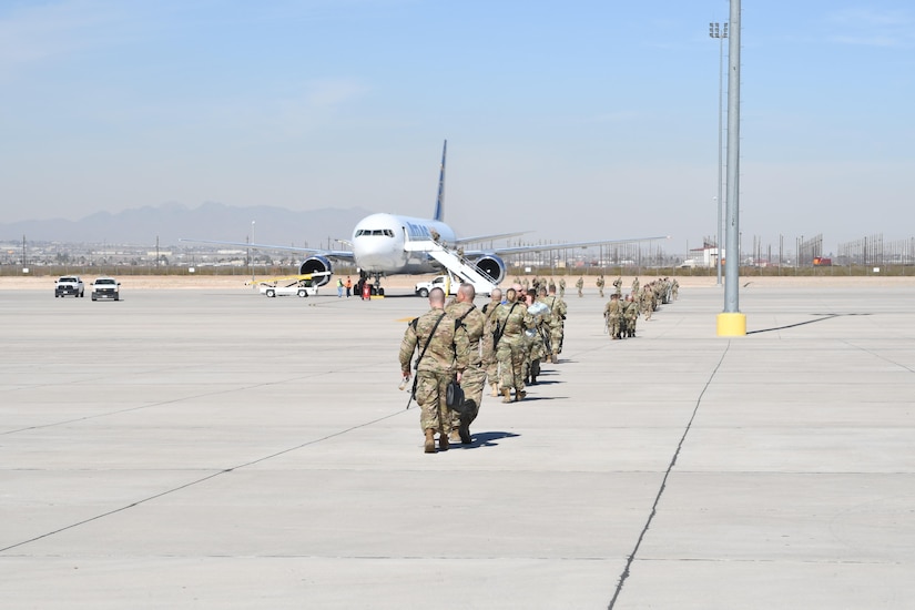 Soldiers assigned to the 207th Engineer Company, Kentucky Army National Guard, and the 215th Engineer Company, Puerto Rico Army National Guard, walk to the aircraft that will transport them to the Middle East at the Silas L. Copeland Arrival/Departure Airfield Control Group here Feb. 2 in support of Operation Freedom’s Sentinel.