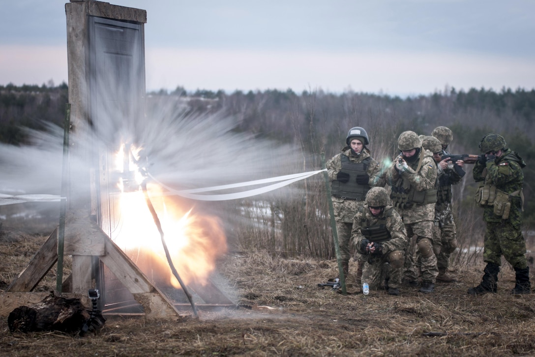 Ukrainian combat training center engineers detonate an explosive charge to breach a door before entering a mock building while training with Canadian and U.S. Army engineers near Yavoriv, Ukraine, Feb. 24, 2017. Army photo by Sgt. Anthony Jones