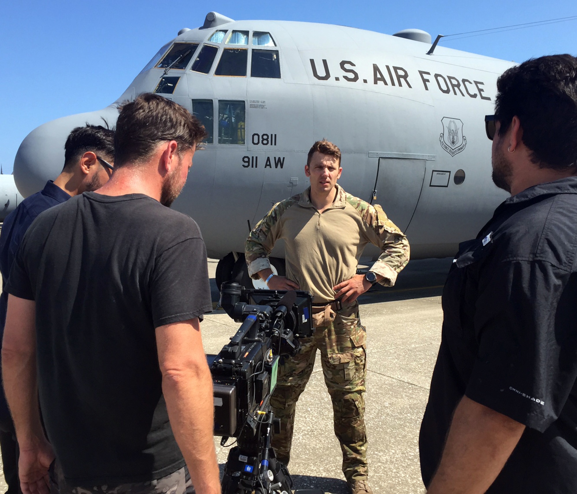 A Fox TV camera crew shoots footage of Tech. Sgt. Ben Domian, a survival, evasion, resistance, and escape specialist with the 920th Rescue Wing, in front of a HC-130 P/N King June 15, 2016 at Patrick Air Force Base, Fla. The network shot footage of Domian to use for its newest reality show, "Kicking and Screaming," which airs March. 9. Domian is one of 20 contestants on the show. (U.S. Air Force photo/Maj. Cathleen Snow)