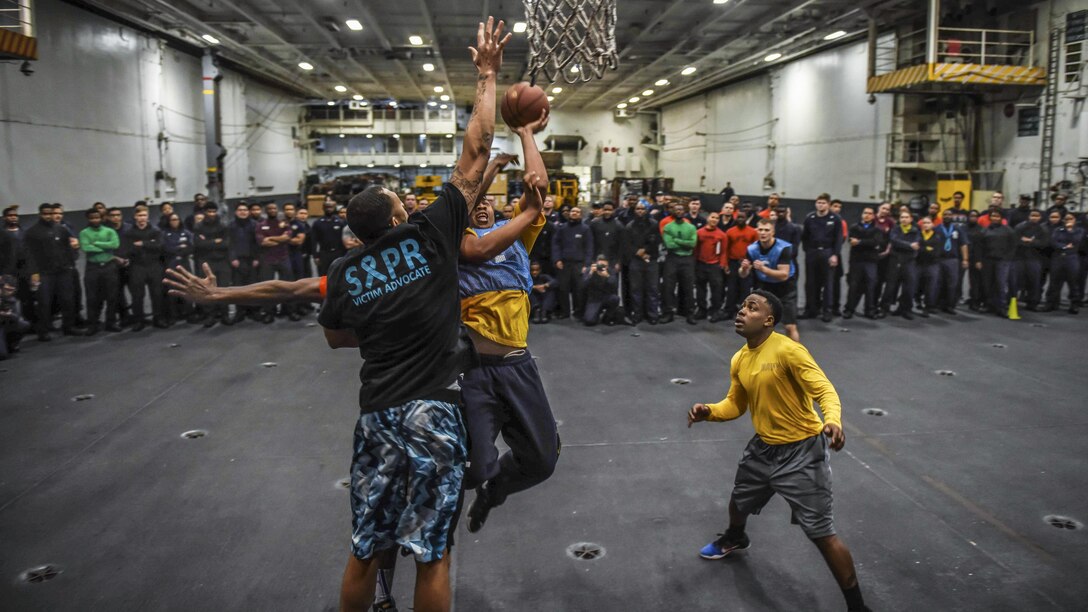 Sailors compete in the final round of a three-on-three basketball tournament in the hangar bay of the USS Theodore Roosevelt in the Pacific Ocean, Feb. 19, 2017. The Theodore Roosevelt is off the coast of Southern California conducting routine training operations. Navy photo by Petty Officer 3rd Class Spencer Roberts