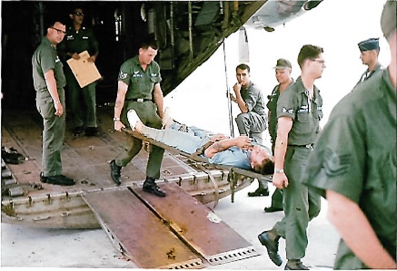 An injured service member is being airlifted to a medical facility during the Vietnam War. The 903rd Aeromedical Evacuation Flight provided medical care to stabilize the patient for evacuation by fixed wing aircraft to medical facilities for further medical care. (Courtesy Photo)