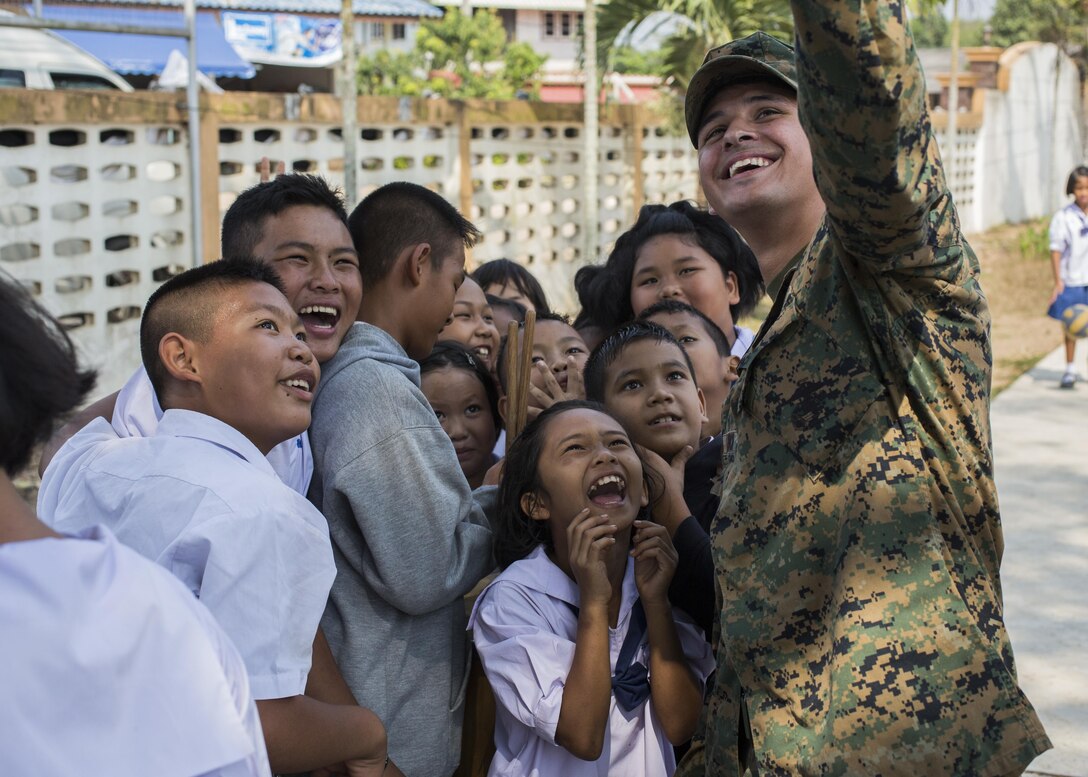 U.S. Marine Corps Cpl. Gabriel Aldrich, with III Marine
Expeditionary Force, takes a photo with Thai students during acommunity relations visit to Ban Chong Kapad School in
Chanthaburi Province, Thailand, during exercise Cobra Gold, Feb. 20, 2017. Cobra Gold, in its 36th iteration, focuses on humanitarian civic action, community engagement, and medical
activities to support the needs and humanitarian interest of civilian populations around the region.
