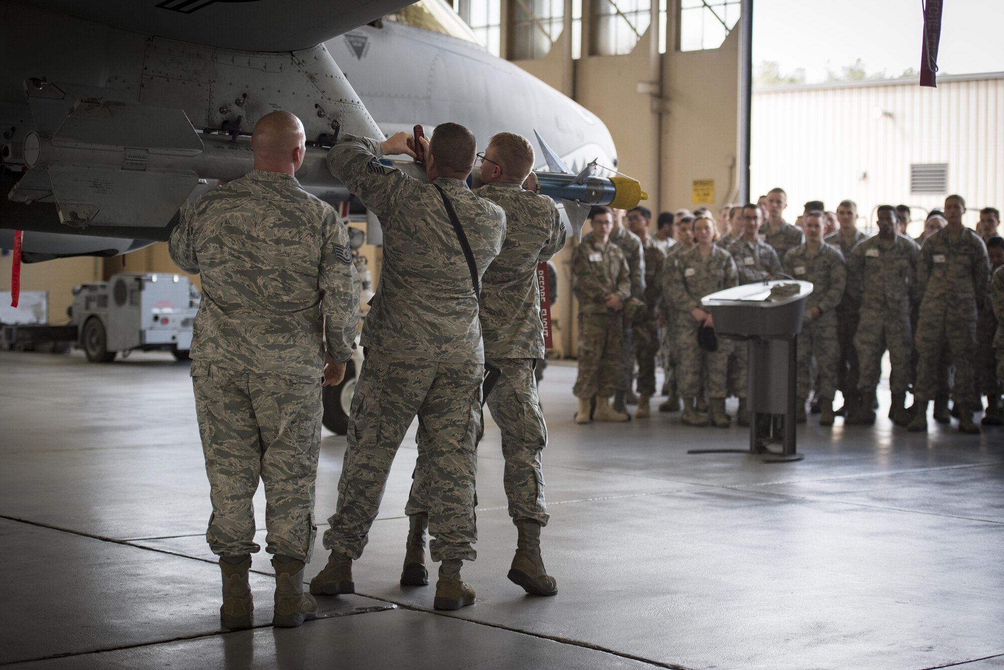 Airmen from the 23d Aircraft Maintenance Squadron demonstrate a weapons load for Airmen and families, Feb. 23, 2017, at Moody Air Force Base, Ga., during the base tour segment of the new in-processing program known as “On-boarding.” Airmen and their families visited the 23d Medical Group, the 820th Base Defense Group, the HH-60G Pave Hawks, and the A-10C Thunderbolt II. (U.S. Air Force photo by Airman 1st Class Lauren M. Sprunk)