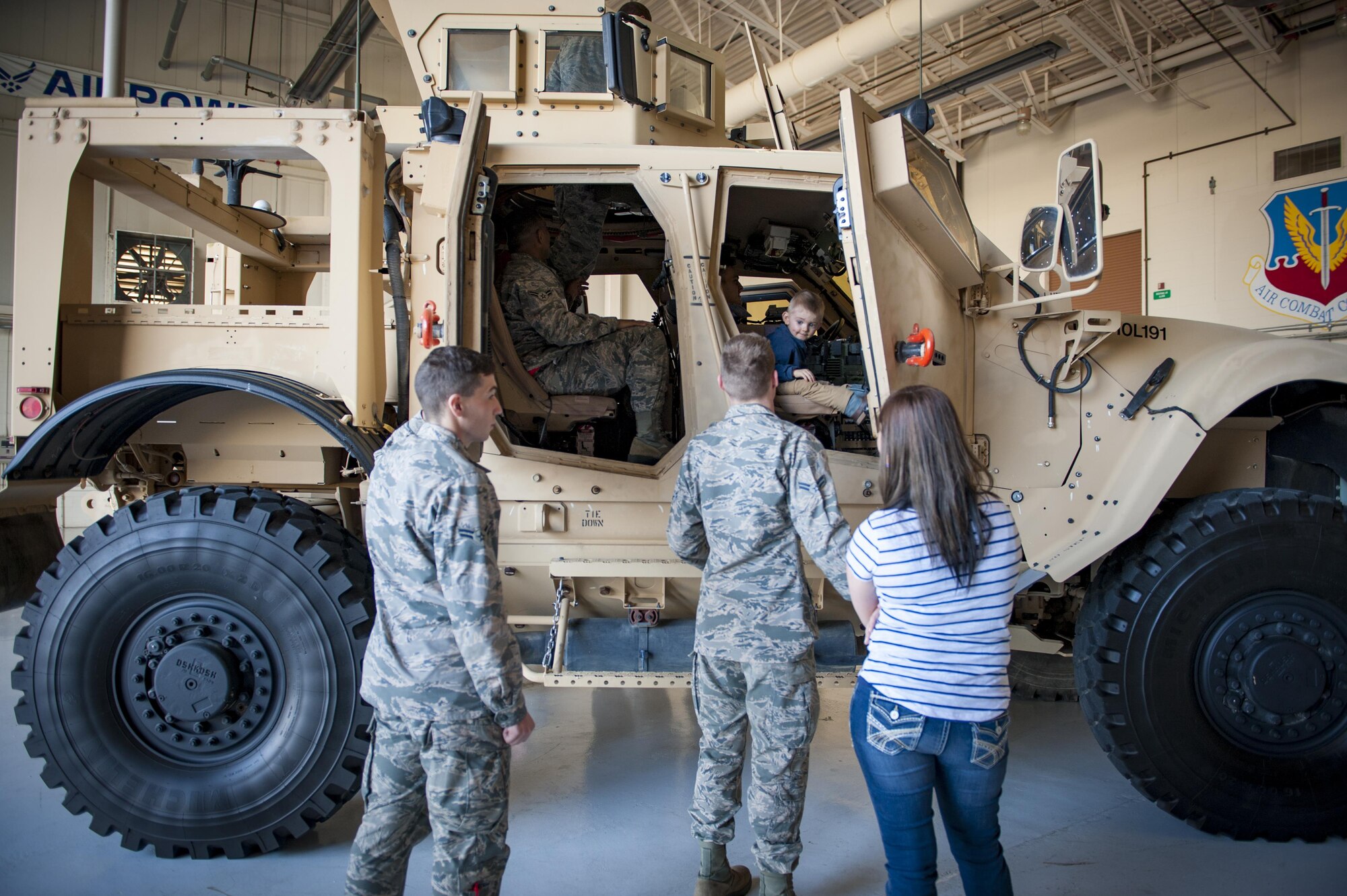 Airmen and families explore the inside of a mine restricted ambush protected vehicle, Feb. 23, 2017, at Moody Air Force Base, Ga., during the in-processing program known as “On-boarding.” Airmen and families received a mission brief, had breakfast with leadership, and took a tour of the base. (U.S. Air Force photo by Airman 1st Class Lauren M. Sprunk)
