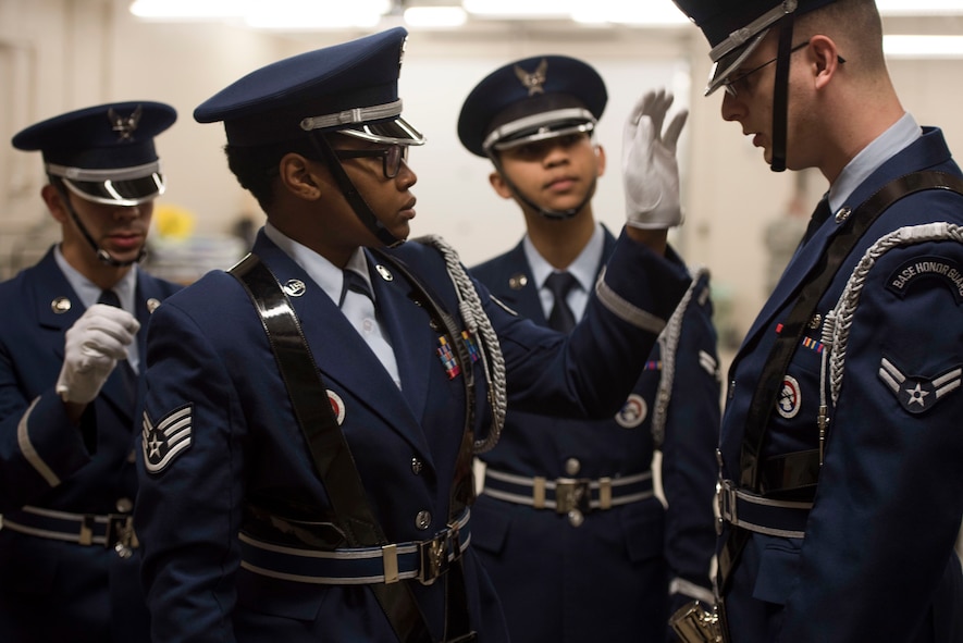 Members of the Ellsworth Honor Guard inspect each other’s uniforms before presenting the colors during a performance by the Offutt Brass at the Performing Arts Center Historic Theater in Rapid City, S.D., on Feb. 22, 2017. Offutt Brass is the brass ensemble of the U.S. Air Force Heartland of America Band that performs around the U.S. to celebrate America and patriotism. (U.S. Air Force photo by Airman 1st Class Randahl J. Jenson) 