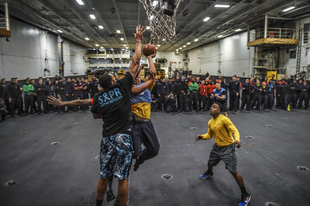 Sailors compete in the final round of a three-on-three basketball tournament in the hangar bay of the USS Theodore Roosevelt in the Pacific Ocean, Feb. 19, 2017. The Theodore Roosevelt is off the coast of Southern California conducting routine training operations. Navy photo by Petty Officer 3rd Class Spencer Roberts
