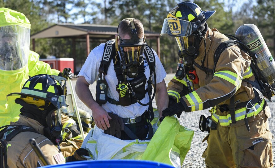 An Airman from the 23d Civil Engineer Squadron bioenvironmental flight moves through a decontamination wash pit during a chemical, biological, radiological and nuclear defense exercise, Feb. 16, at Moody Air Force Base, Ga. Moody’s Wing Inspection Team tested the 23d CES fire department, emergency management flight and bioenvironmental flight on procedures, response and effective communication between the units. (U.S. Air Force photo by Airman 1st Class Janiqua P. Robinson)