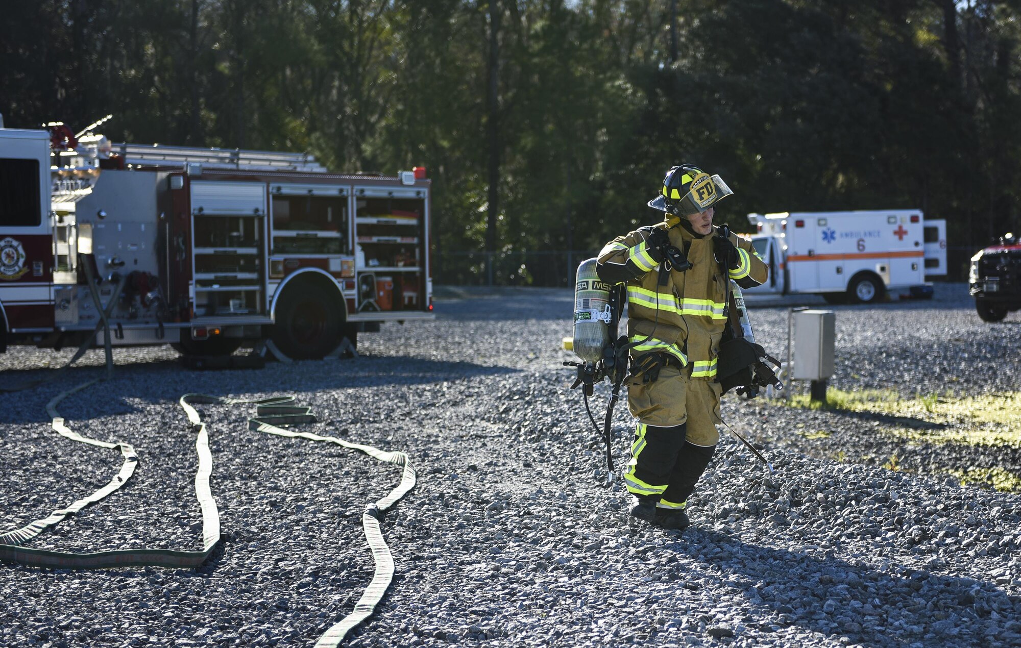 A firefighter from the 23d Civil Engineer Squadron carries oxygen tanks to the decontamination wash pit during a chemical, biological, radiological and nuclear defense exercise, Feb. 16, at Moody Air Force Base, Ga. Moody’s Wing Inspection Team tested the 23d CES fire department, emergency management flight and bioenvironmental flight on procedures, response and effective communication between the units. (U.S. Air Force photo by Airman 1st Class Janiqua P. Robinson)