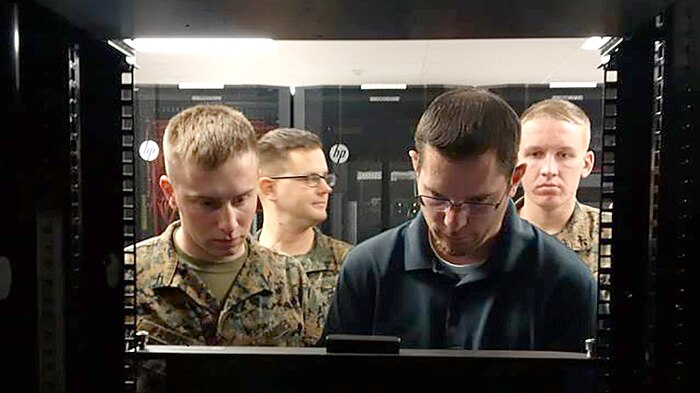 Jason Hessler, an Automated Message Handling System support engineer, trains Marines from Marine Corps Installations West G-6 on the Hyper-Converged Infrastructure system Jan. 11, aboard Camp Pendleton, California. HCI is a virtualization solution that replaces traditional servers, and combines storage and compute functions into a single machine to save cost, energy and space. Marine Corps Systems Command’s Information Systems and Infrastructure recently installed the technology at Camp Lejeune, North Carolina, and Camp Pendleton, California, to support Organizational Messaging Service, which is used to send operational and administrative messages across the Corps. (Courtesy photo)