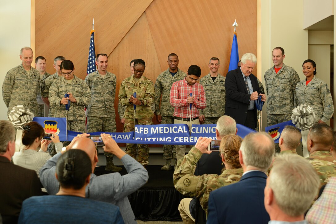U.S. Air Force, 9th Air Force, Air Combat Command and Team Shaw members participate in a ribbon cutting ceremony for the new 20th Medical Group clinic at Shaw Air Force Base, S.C., Feb. 24, 2017. The new facility will continue to provide services offered in the previous building, to include: family health, women's health, mental health, physical therapy, optometry, pharmacy, and laboratory services. (U.S. Air Force photo by Airman 1st Class Kathryn R.C. Reaves)