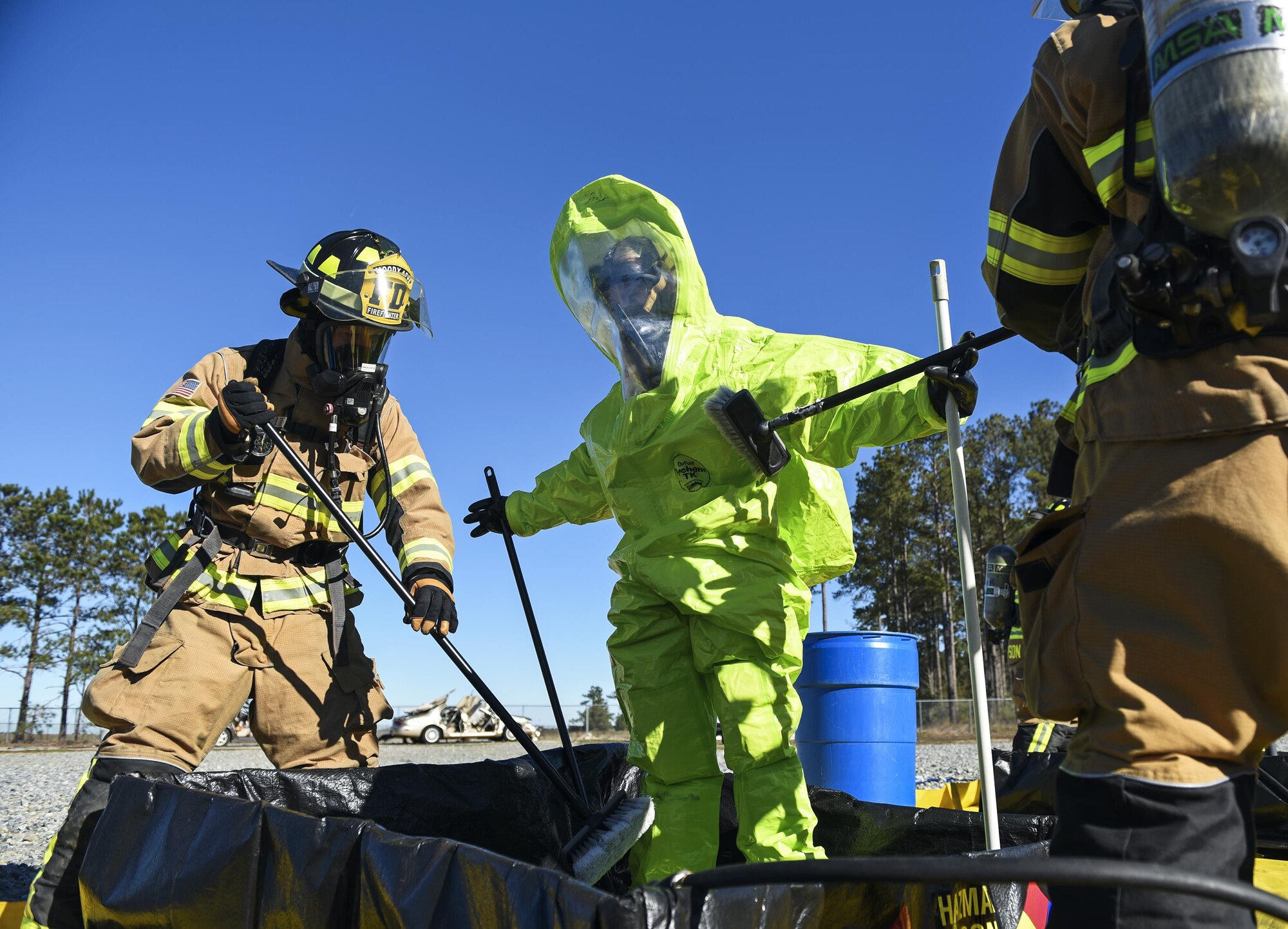 Firefighters from the 23d Civil Engineer Squadron decontaminate an Airman during a chemical, biological, radiological and nuclear defense exercise, Feb. 16, at Moody Air Force Base, Ga. Moody’s Wing Inspection Team tested the 23d CES fire department, emergency management flight and bioenvironmental flight on procedures, response and effective communication between the units. (U.S. Air Force photo by Airman 1st Class Janiqua P. Robinson)
