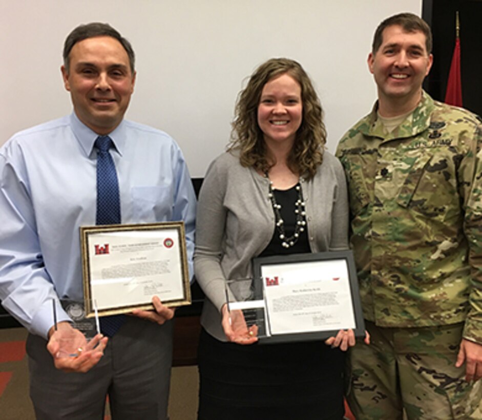 Lt. Col. Stephen Murphy (Right), U.S. Army Corps of Engineers Nashville District commander, presents achievement awards to Eric Crafton and Mary Katherine Keith during a staff meeting Feb. 16, 2017 at the Nashville District Headquarters in Nashville, Tenn. They were two of seven team members who developed a groundbreaking land exchange process that enabled the Nashville District to obtain land needed for a roller compacted concrete berm adjacent to the Center Hill Lake saddle dam at Lancaster, Tenn.