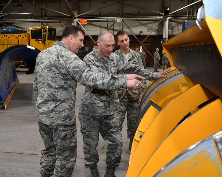 Maj. Gen. Christopher Bence, Expeditionary Center commander, and Chief Master Sgt. Larry Williams, Expeditionary Center command chief, look over the 319th Civil Engineer Squadron’s winter road maintenance vehicles on Grand Forks Air Force Base, N.D., Feb. 23, 2017. Senior Airman Dylan Harrison, 319th CES pavement and equipment apprentice, provided a tour of the “Snow Barn” to EC leadership and explained how the equipment impacts mission operations at Grand Forks AFB.(U.S. Air Force photo by Airman 1st Class Elijaih Tiggs)