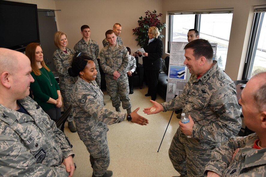 Maj. Gen. Christopher Bence, Expeditionary Center commander, coins Staff Sgt. Cologne Shepherd, 319th Air Base Wing equal opportunity specialist, on Grand Forks Air Force Base, N.D., Feb. 24, 2017. Shepherd was recognized as one of many star performers in the wing by the EC leadership during their visit. (U.S. Air Force photo by Airman 1st Class Elijaih Tiggs)