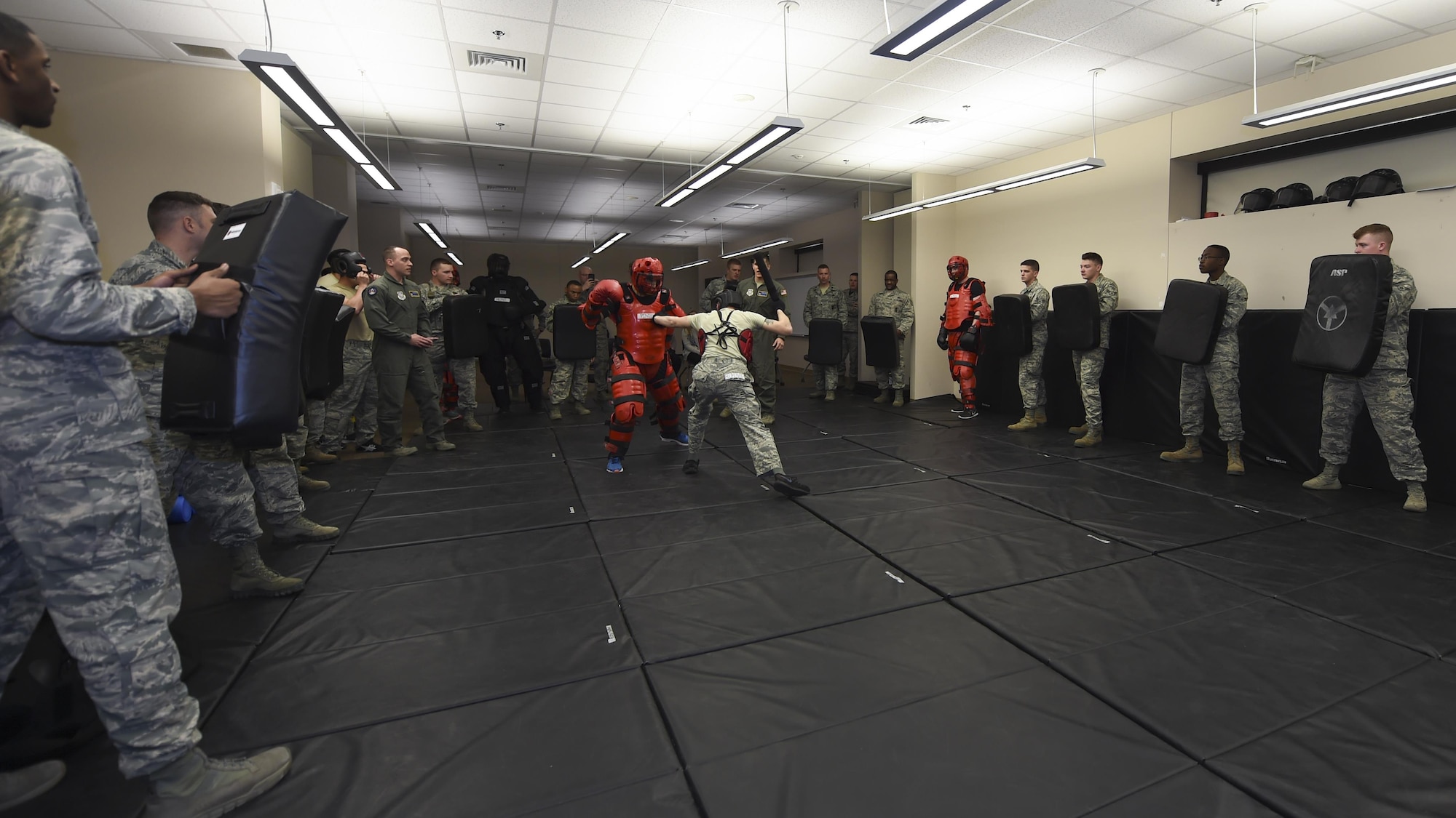 U.S. Air Force Airmen from the 19th Security Forces Squadron form a barrier around Airman 1st Class Timothy Bukovich, 19th SFS patrolman, during close combat training, Feb. 17, 2017, at Little Rock Air Force Base, Ark. The “Red Man” exercise was the capstone event of a weeklong course of Phoenix Raven instruction for Airmen attempting to join the little-known team of elite security commandos. (U.S. Air Force photo/Senior Airman Harry Brexel)