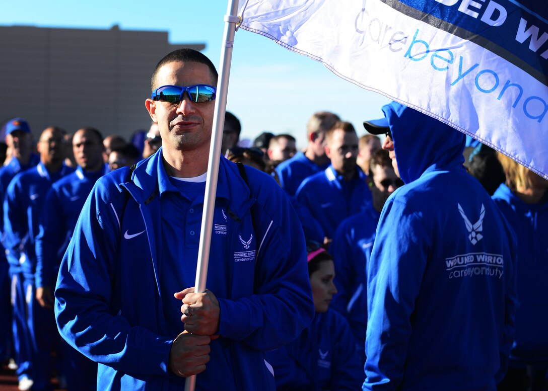 U.S. Air Force retired Tech. Sgt. Freddie Rosario, 2017 AF Warrior Game Trials competitor, carries the Wounded Warrior flag during the opening ceremony of the Air Force trials at the Warrior Fitness Center Feb. 24, 2017 at Nellis Air Force Base, Nev. Dozens of U.S. Air Force, U.S. Army, Australian and Great Britain wounded warriors gathered for the fourth annual competition. (U.S. Air Force photo by Senior Airman Chip Pons)