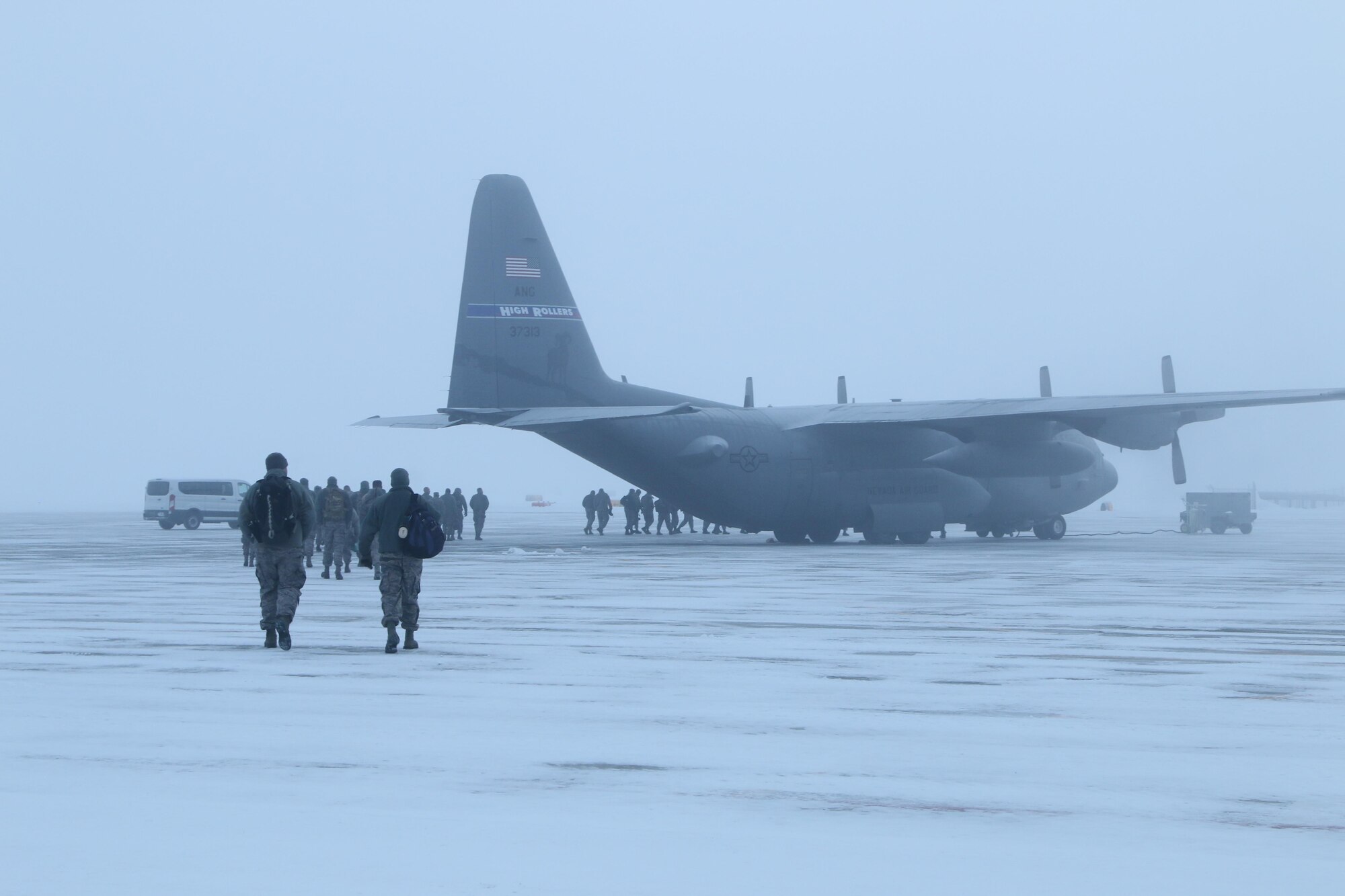 Airmen from the 173rd Fighter Wing walk out in the -13 degree weather to board a Texas Air National Guard C-130 in preperation for the wing's deployment to Tucson, Arizona January 6, 2017 at Kingsley Field in Klamath Falls, Oregon.  The 173rd Fighter Wing spent two weeks training with the Airzona ANG flying dissimilar air combat training with their F-16s.  (U.S. Air National Guard photo by Master Sgt. Jennifer Shirar)