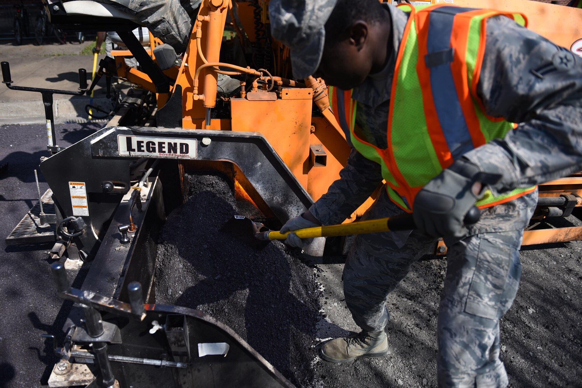 U.S. Air Force Airman 1st Class Lawrence Amihere, 19th Civil Engineer Squadron pavement and heavy equipment journeyman, performs asphalt paving operations Jan. 7, 2017, at Little Rock Air Force Base, Ark. Airmen of the pavements and heavy equipment shop, also known as “Dirt Boyz”, work long hours in unforgiving weather to maintain the base’s airfield, roads, fences and drainage systems. (U.S. Air Force photo by Airman 1st Class Kevin Sommer Giron)