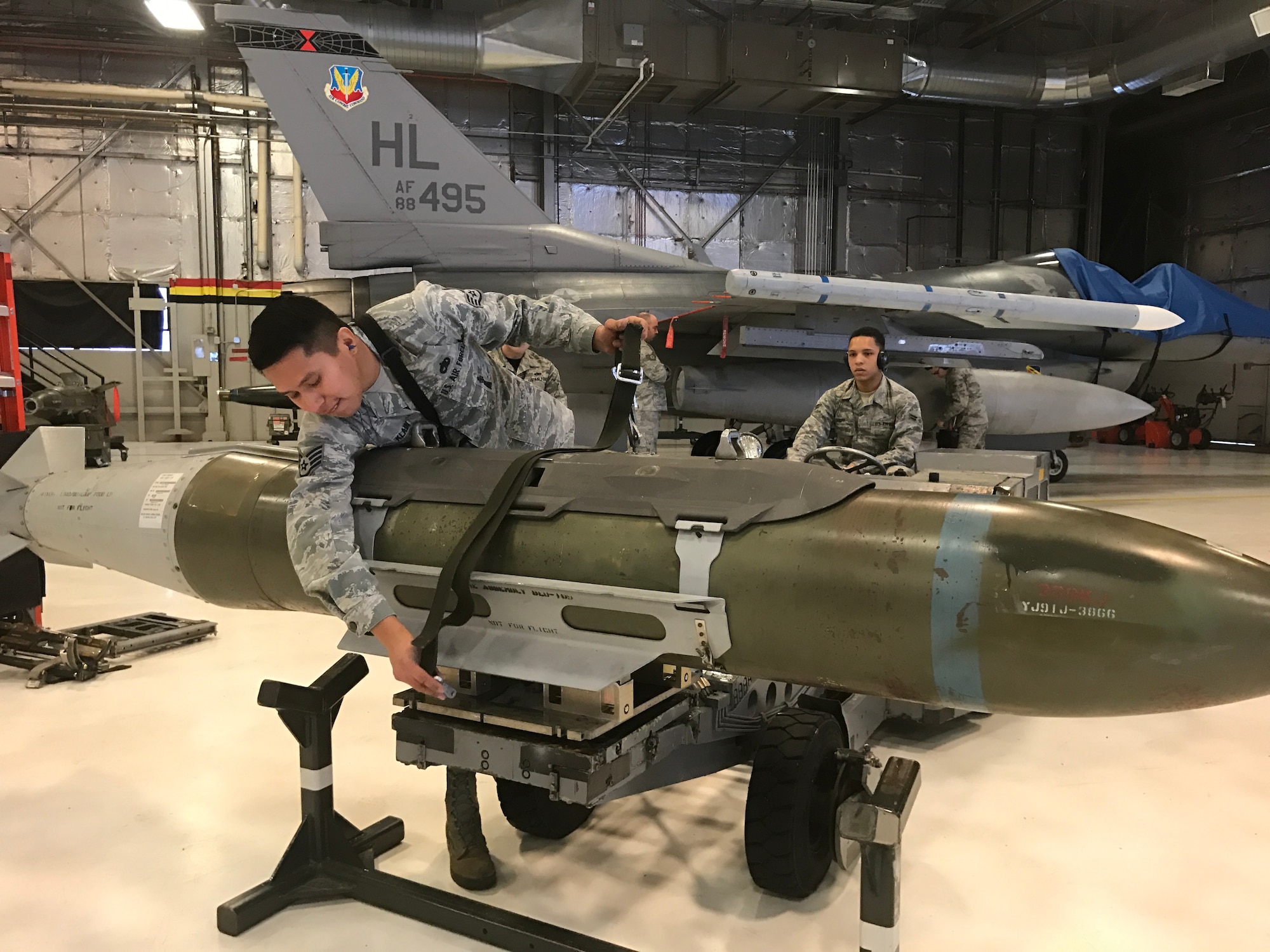 421st Aircraft Maintenance Unit teammates Staff Sgt. Lance Klain and Airman 1st Class Jacob Happ secure a weapon during the 388th and 419th Fighter Wing’s Load Crew of the Year competition at Hill Air Force Base Feb. 24. (U.S. Air Force photo by Donovan K. Potter)