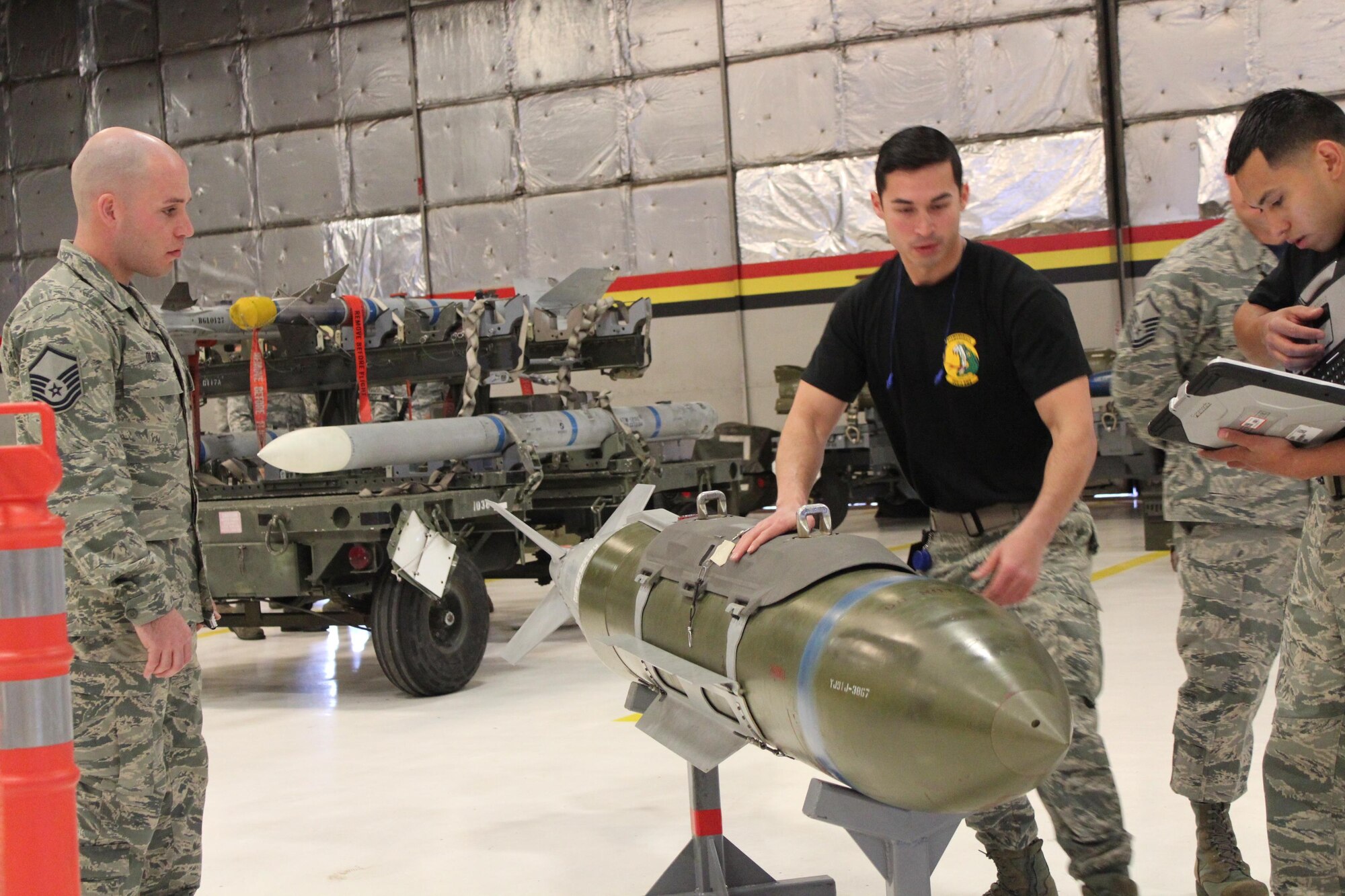 Master Sgt. Colin Olson of the 419th Maintenance Group inspects the work of 466th Aircraft Maintenance Unit teammates Tech. Sgt. Aaron Ramirez and Staff Sgt. Justin Crosby during the 388th and 419th Fighter Wing’s Load Crew of the Year competition at Hill Air Force Base Feb. 24. (U.S. Air Force photo by Donovan K. Potter)