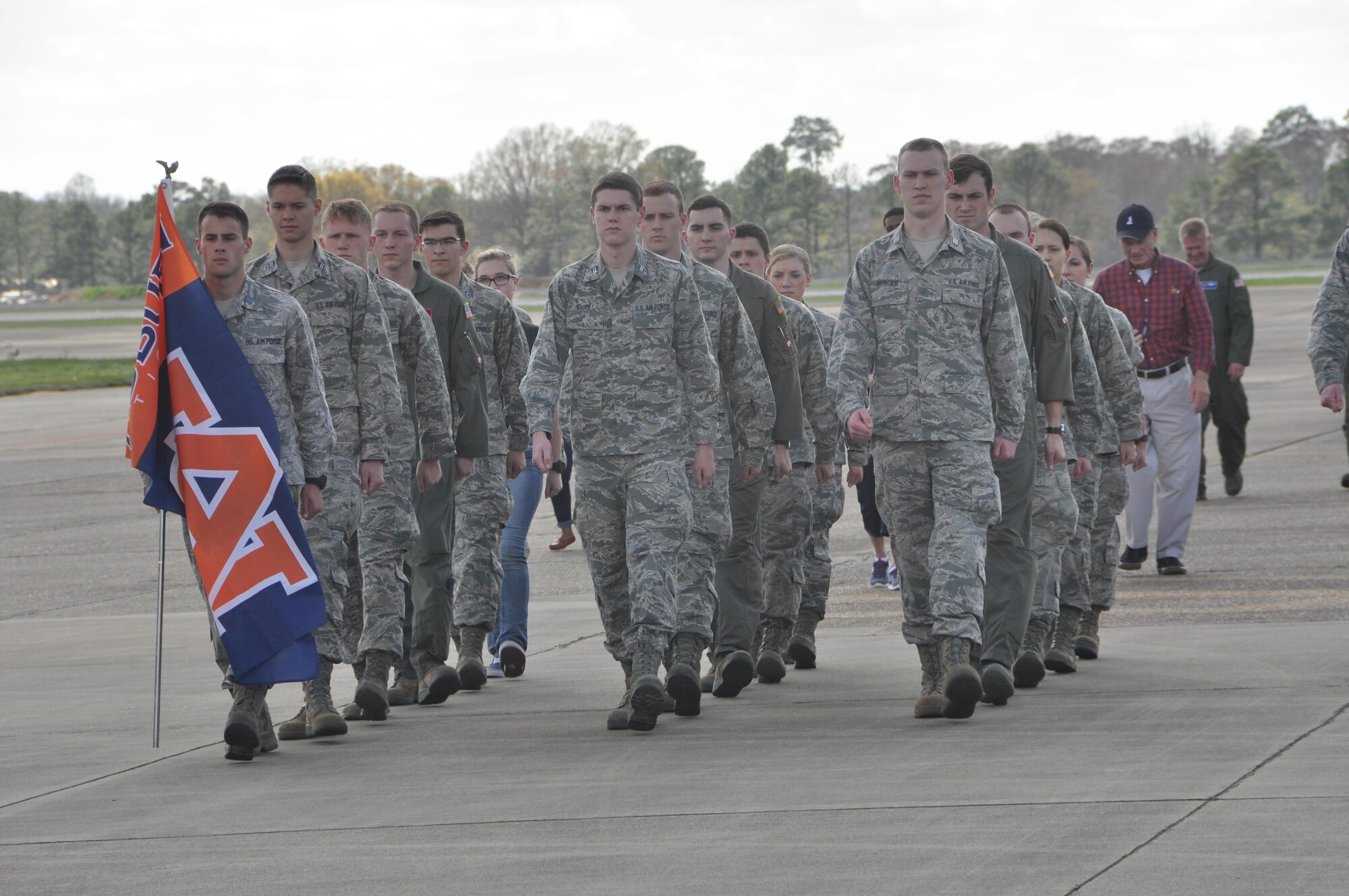Cadets from Auburn University’s Air Force ROTC Detachment march an Auburn flag from Aircraft Tail Number 85-0040 known as "War Eagle" to Aircraft Tail Number 91-9142 during a Transfer of Heritage ceremony Feb. 24, at Maxwell Air Force Base.  Aircraft 91-9142, which will now carry the “War Eagle” legacy, came to the 908th Airlift Wing at Maxwell from the 914th Airlift Wing at Niagara Falls Air Reserve Station, New York. (U.S. Air Force photo by Bradley J. Clark)