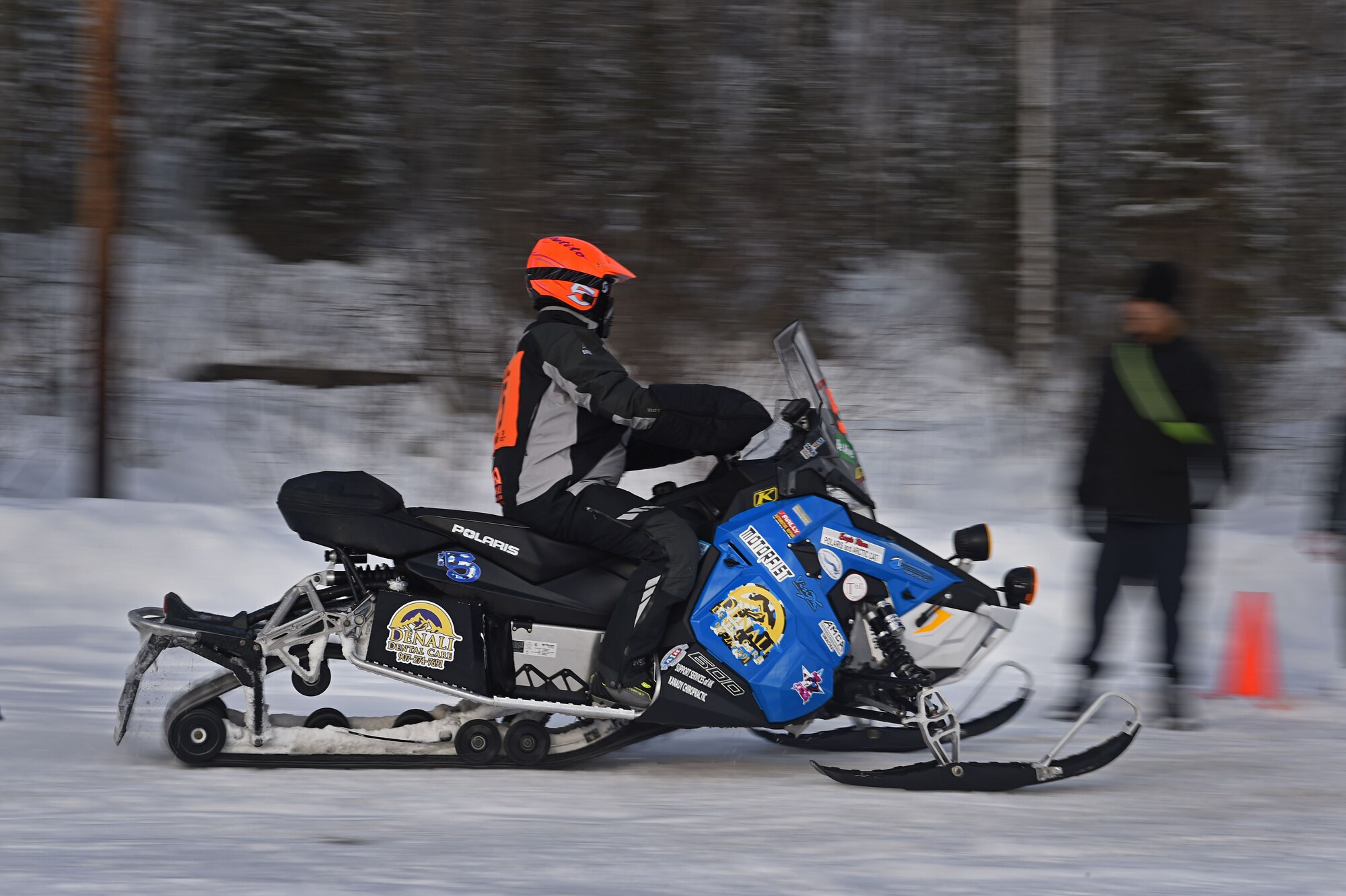 A snowmobile racer rides through trails at Joint Base Elmendorf-Richardson, Alaska, during the Iron Dog race Feb. 18, 2017. Military personnel and families gathered to high-five racers as they passed by Otter Lake. 