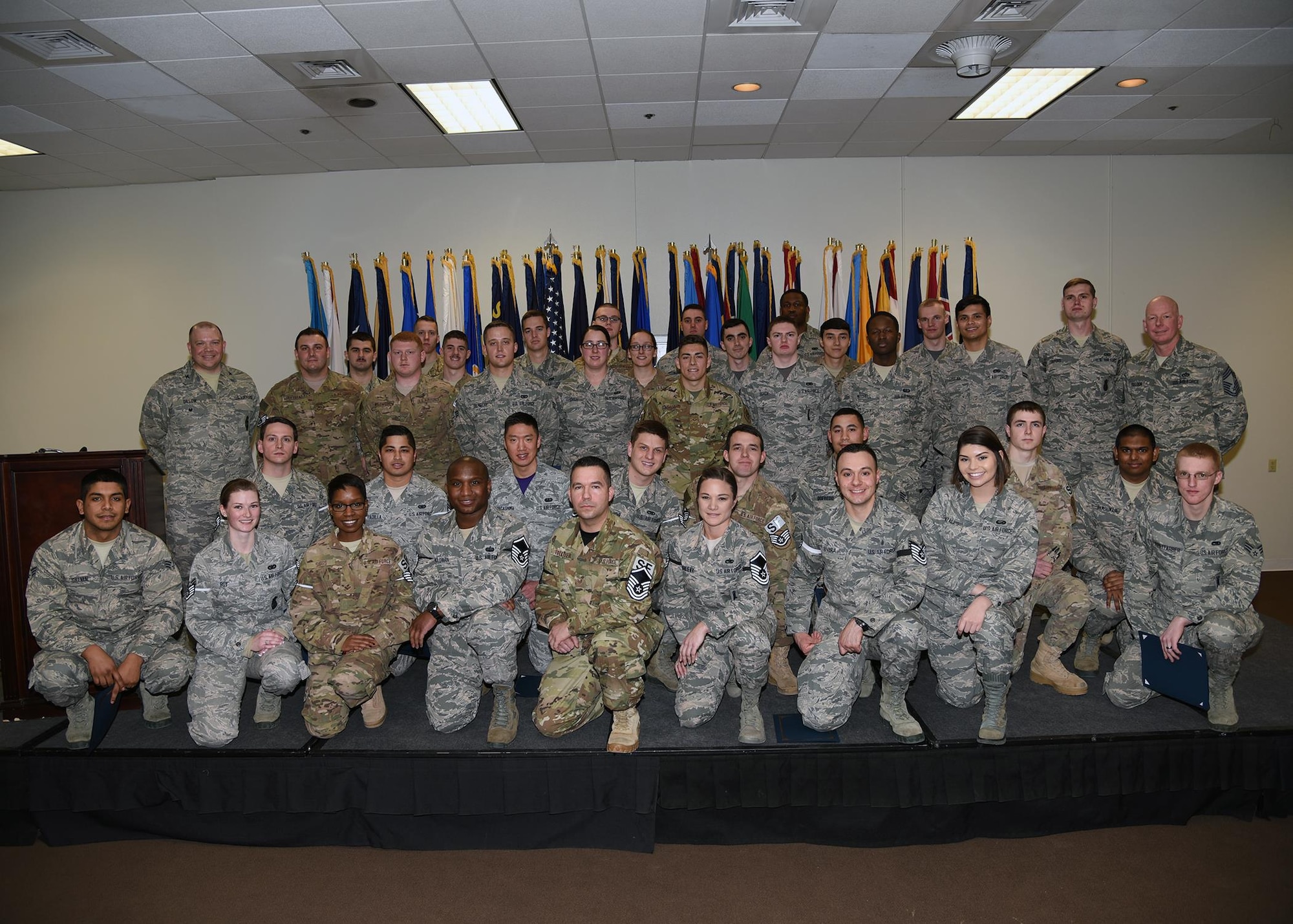 Enlisted Airmen who promoted in February pose with Col. Matthew Dillow, 90th Missile Wing vice commander and Chief Master Sgt. Christopher Pollock, 90th Maintenance Support Group chief enlisted manager on F.E. Warren Air Force Base, Wyo., Feb. 24, 2017. Each month the Mighty Ninety hosts a celebration for enlisted promotees from the base. (U.S. Air Force photo by Glenn S. Robertson)