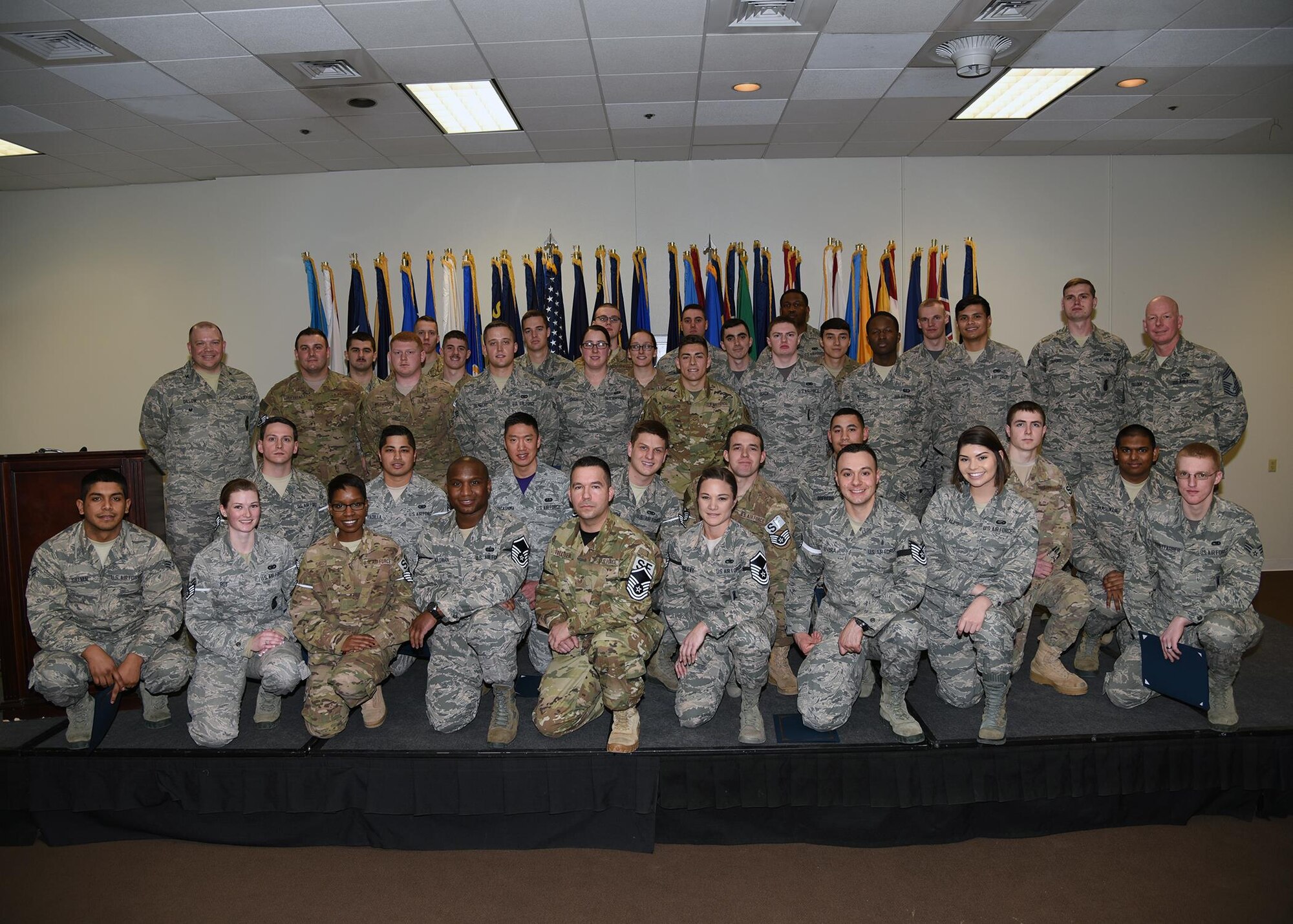 Enlisted Airmen who promoted in February pose with Col. Matthew Dillow, 90th Missile Wing vice commander and Chief Master Sgt. Christopher Pollock, 90th Maintenance Support Group chief enlisted manager on F.E. Warren Air Force Base, Wyo., Feb. 24, 2017. Each month the Mighty Ninety hosts a celebration for enlisted promotees from the base. (U.S. Air Force photo by Glenn S. Robertson)