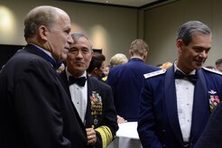 Alaska Gov. Bill Walker (right), Navy Adm. Harry Harris Jr. (center), U.S. Pacific Command commander, and Air Force Lt. Gen. Kenneth Wilsbach (left), commander of the Alaskan Region, North American Aerospace Defense Command, Alaskan Command, U.S. Northern Command, and 11th Air Force, mingle during the social hour at the ASYMCA’s 40th annual Salute to the Military at the Dena’ina Center, Anchorage, Alaska, Feb. 18, 2017. Since the Navy League’s conception of the ASYMCA in 1977, the program has annually honored all branches of service and has become the longest-running annual event hosted by a non-profit organization. 