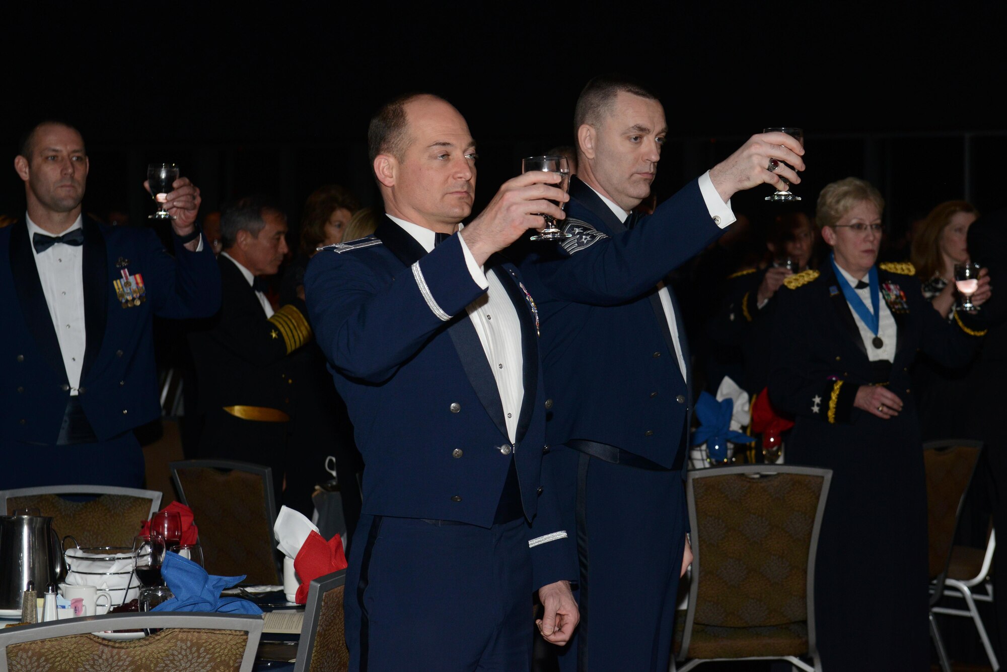 Air Force Col. George T.M. Dietrich III (center), 673d Air Base Wing and Joint Base Elmendorf-Richardson commander, and Air Force Chief Master Sgt. Garry Berry II, 673d ABW and JBER command chief master sergeant, toast the POW/MIA table ceremony during the ASYMCA’s 40th annual Salute to the Military at the Dena’ina Center, Anchorage, Alaska, Feb. 18, 2017. Since the Navy League’s conception of the ASYMCA in 1977, the program has annually honored all branches of service and has become the longest-running annual event hosted by a non-profit organization.