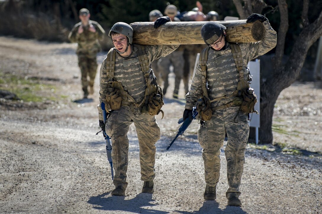 Air Force Academy cadets carry a log during a medical evacuation march at Camp Bullis, Texas, Feb. 16, 2017. The cadets were required to trek multiple miles carrying logs and simulated casualties to a medical evacuation zone in limited time. Air Force photo by Airman 1st Class Daniel Snider