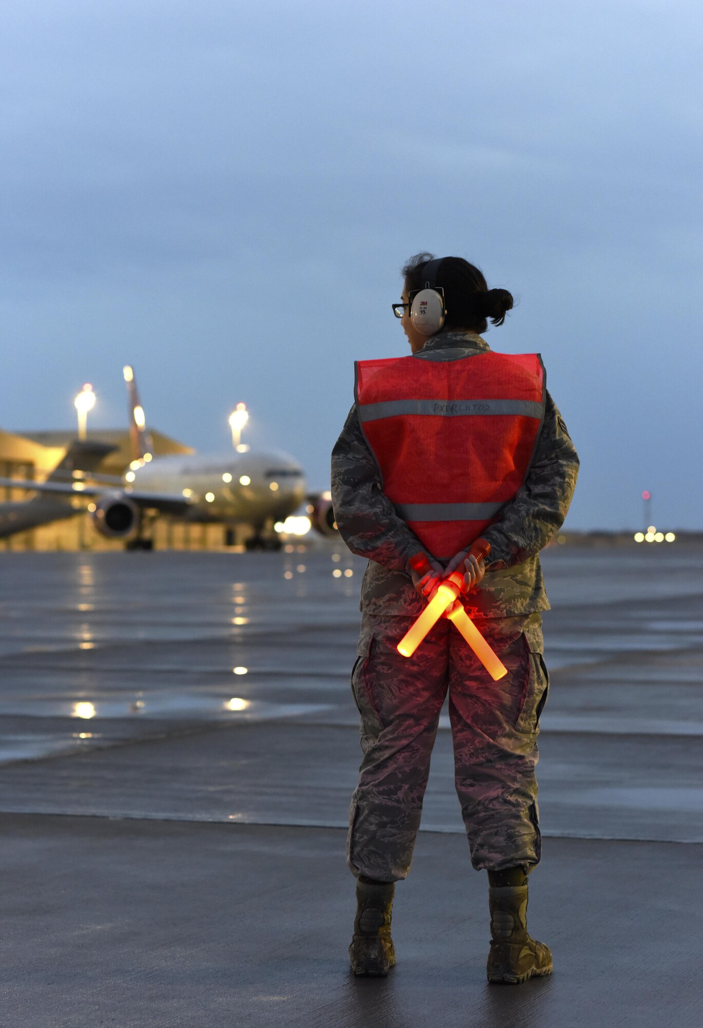 U.S. Air Force Senior Airman Sylvia Feigum, a combat oriented supply organization journeyman with the 8th Expeditionary Air Mobility Squadron, prepares to marshal in a Boeing 777-200 at Al Udeid Air Base, Qatar, Feb. 16, 2017. Feigum’s primary role as a COSO is to coordinate supply requests for C-17 Globemaster III aircraft maintenance, but because of her additional duties here she also has the opportunity to guide aircraft to their parking spot. This particular aircraft happened to be carrying her husband, U.S. Air Force Senior Airman Matthew Feigum, a combat crew communications journeyman with the 816th Expeditionary Air Lift Squadron. (U.S. Air Force photo by Senior Airman Cynthia A. Innocenti)