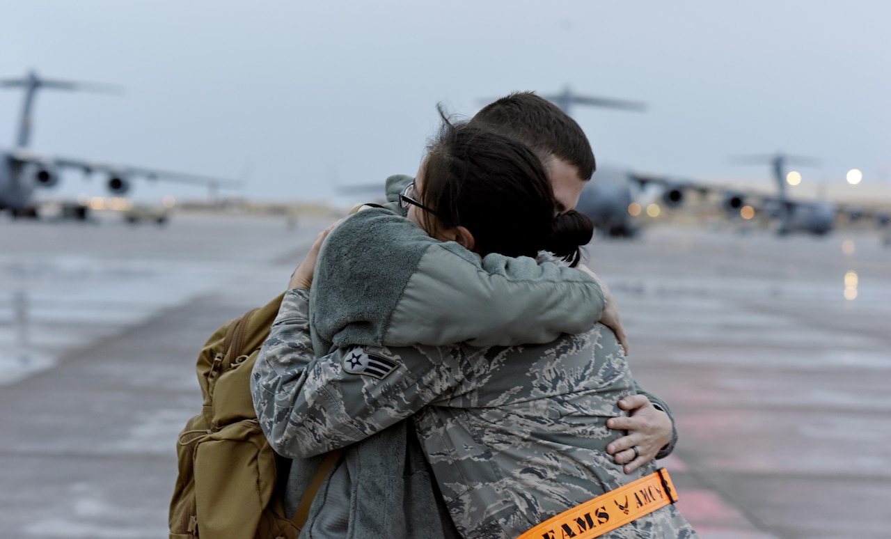 U.S. Air Force Senior Airman Sylvia Feigum, a combat oriented supply organization journeyman with the 8th Expeditionary Air Mobility Squadron, right, embraces her husband U.S. Air Force Senior Airman Matthew Feigum, a combat crew communications journeyman with the 816th Expeditionary Air Lift Squadron after marshaling in the rotator he arrived on at Al Udeid Air Base, Qatar, Feb. 16, 2017. (U.S. Air Force photo by Senior Airman Cynthia A. Innocenti)
