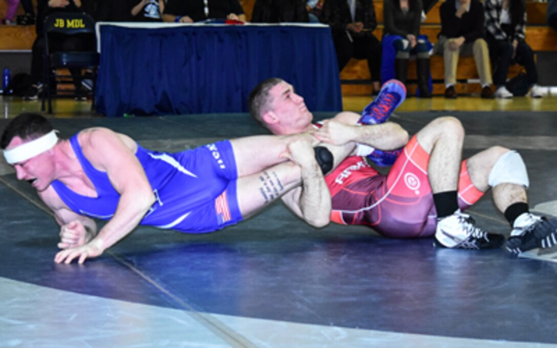 Matthew Brown of the U.S. Army locks up an ankle lace on Tyler Westlund of the Air Force on the way to a technical fall victory at 74 kg. Photo by Richard Immel.
