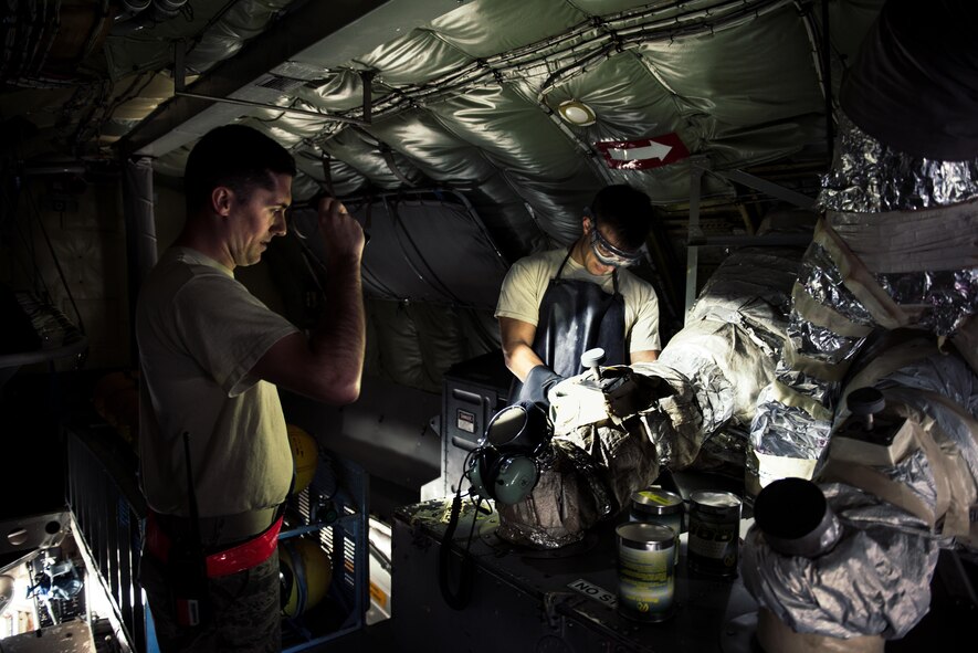 U.S. Air Force Staff Sgt. Nicholas Jaeger and Airman 1st Class Bradley Romaker, 909th Aircraft Maintenance Unit aerospace propulsion technicians, prepare an auxiliary power unit onboard a KC-135R Stratotanker Feb. 16, 2017, at Kadena Air Base, Japan. The auxiliary power unit is one method used to provide power to the aircraft while on the ground.  (U.S. Air Force photo by Senior Airman Omari Bernard/Released)