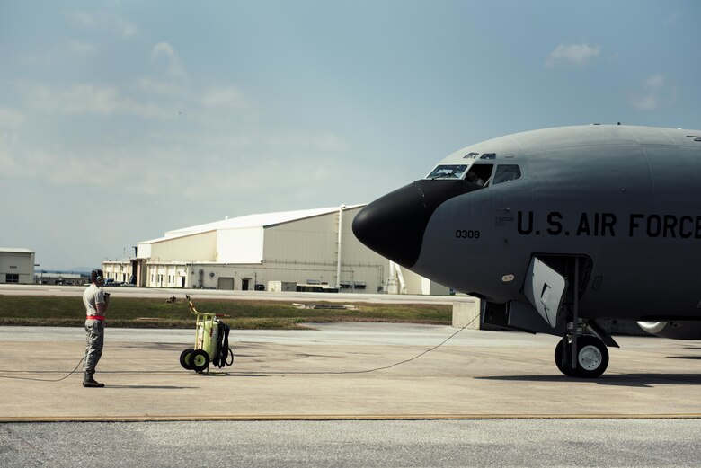 U.S. Air Force Airman 1st Class Weston Rutherford, 909th Aircraft Maintenance Unit aerospace propulsion apprentice, watches for discrepancies outside a KC-135R Stratotanker during an engine power run Feb. 16, 2017, at Kadena Air Base, Japan. Rutherford looks for discrepancies such as leaks, smoke or damage during the power run.  (U.S. Air Force photo by Senior Airman Omari Bernard/Released)