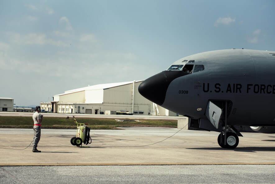 U.S. Air Force Airman 1st Class Weston Rutherford, 909th Aircraft Maintenance Unit aerospace propulsion apprentice, watches for discrepancies outside a KC-135R Stratotanker during an engine power run Feb. 16, 2017, at Kadena Air Base, Japan. Rutherford looks for discrepancies such as leaks, smoke or damage during the power run.  (U.S. Air Force photo by Senior Airman Omari Bernard/Released)