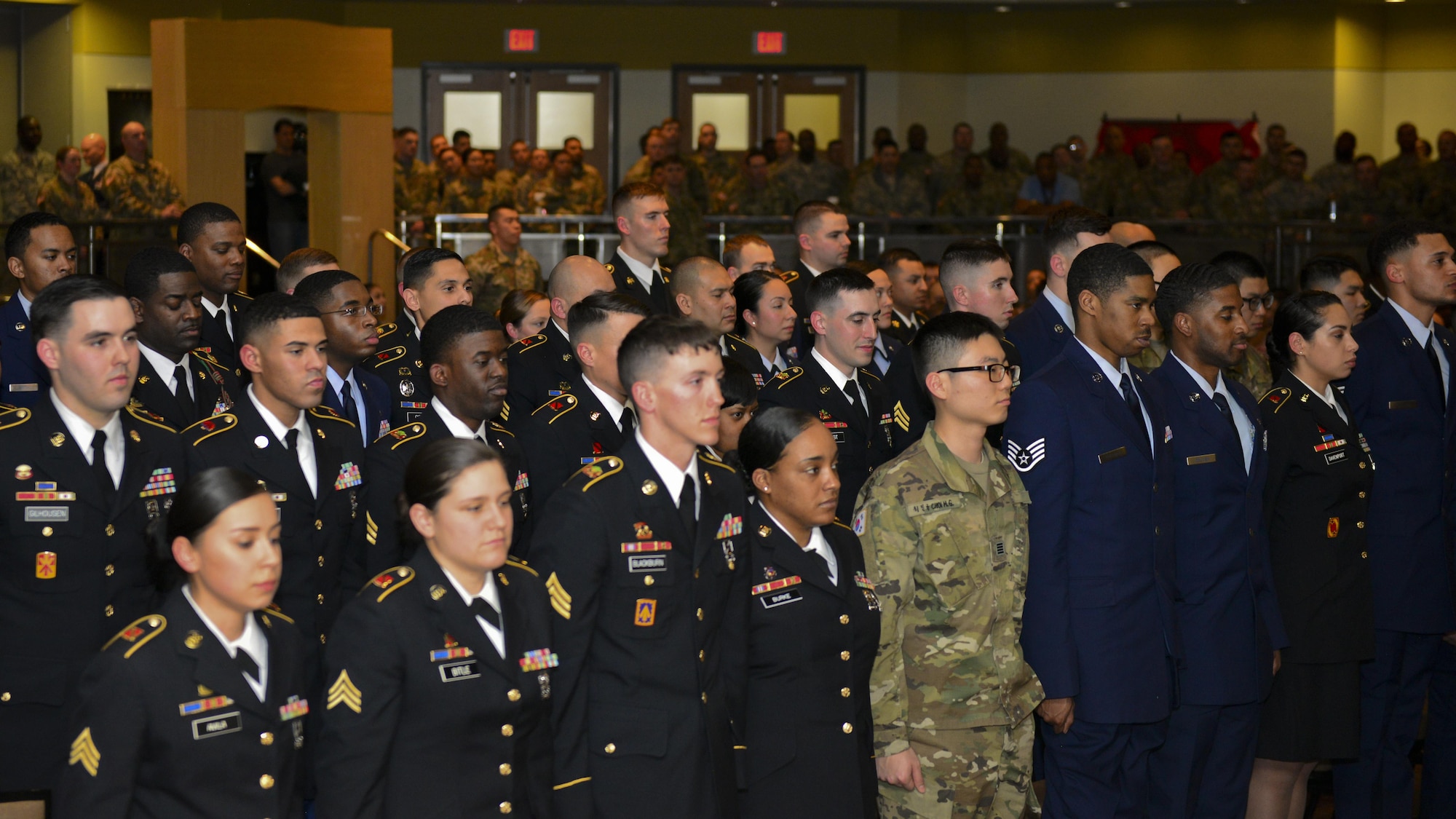 Soldiers, Korean Augmentees to the United States Army and Airmen assigned to 35th Air Defense Artillery Brigade and the 51st Fight Wing, respectively, stand during a joint noncommissioned officer ceremony at Osan Air Base, Republic of Korea, Feb. 16, 2017. The event formally recognized recently promoted Army sergeants and Air Force staff sergeants into the storied U.S. military NCO corps. (U.S. Air Force photo by Staff Sgt. Victor J. Caputo)