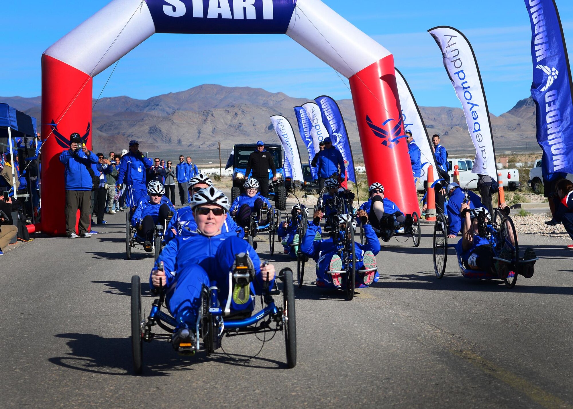 U.S. Air Force retired Senior Airman Jamie Biviano, 2017 AF Trials competitor, departs the start line on her incumbent cycle at Red Horse Feb. 25, 2017 at Nellis Air Force Base, Nev. Biviano took first place in her heat for the cycling competition portion of the trials. (U.S. Air Force photo by Staff Sgt. Alexx Pons) 