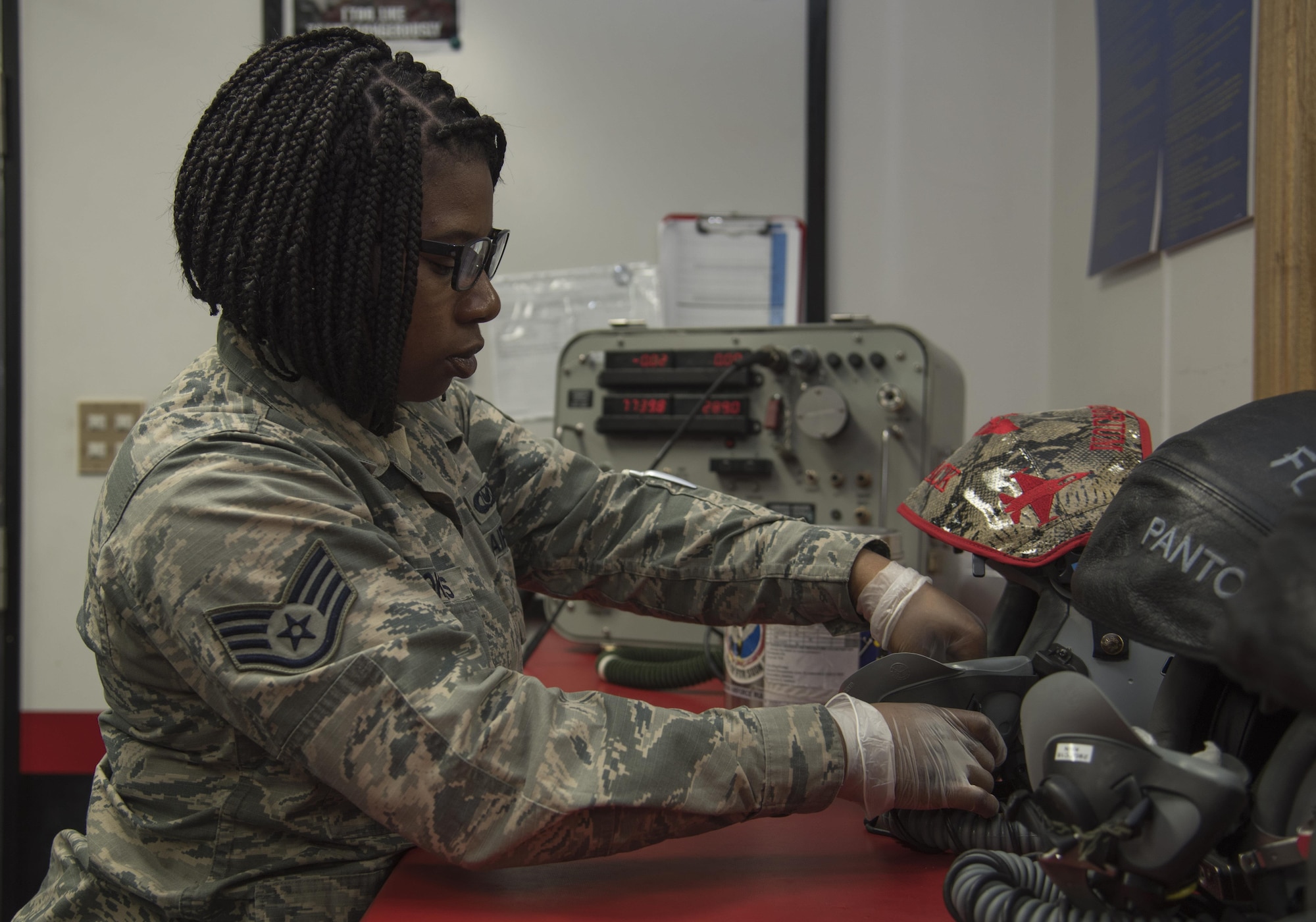 U.S. Air Force Staff Sgt. Faitha Brookins, the 35th Operations Support Squadron aircrew flight equipment NCO in charge, cleans a joint mounted cueing system helmet at Misawa Air Base, Japan, Feb. 8, 2017. Every day the AFE shop maintains the cleanliness and functionality of the pilot's equipment while performing thorough routine checks during their shift. (U.S. Air Force photo by Airman 1st Class Sadie Colbert)