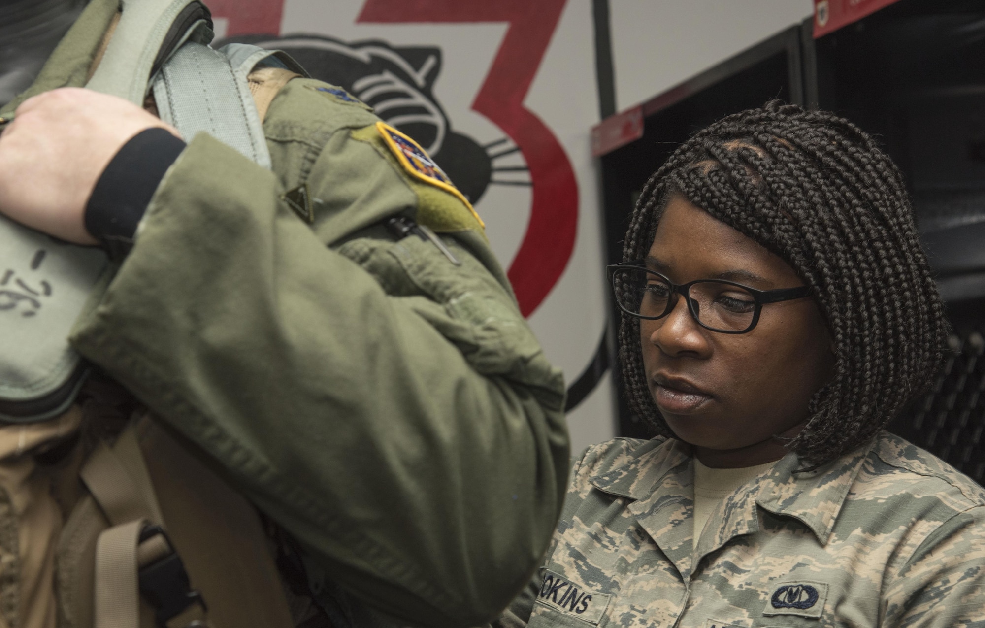 U.S. Air Force Col. Travis Rex, left, the 35th Fighter Wing vice commander, receives a pre-flight inspection by Staff Sgt. Faitha Brookings, right, the 35th Operations Support Squadron aircrew flight equipment NCO in charge, at Misawa Air Base, Japan, Feb. 8, 2017. After donning flight equipment, AFE personnel jolt and tug their suits ensuring survival amenities are secured and no tears or holes formed in their uniform. (U.S. Air Force photo by Airman 1st Class Sadie Colbert)