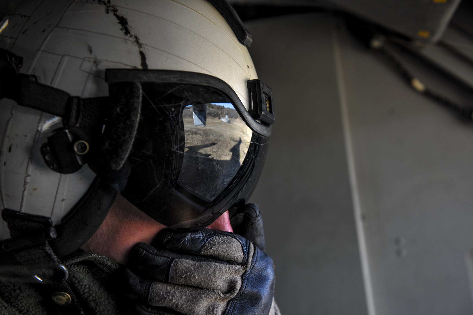 U.S. Marine Ryan Reuscher, an MV-22 Osprey tiltrotor crew chief assigned to Marine Medium Tiltrotor Squadron (VMM) 265, speaks into his headset on a flight over Kunsan Air Base, Republic of Korea, Feb. 2, 2017. Reuscher assisted by watching and notifying the pilots of debris and other aircraft in their vicinity. (U.S. Air Force photo by Senior Airman Colville R. McFee)